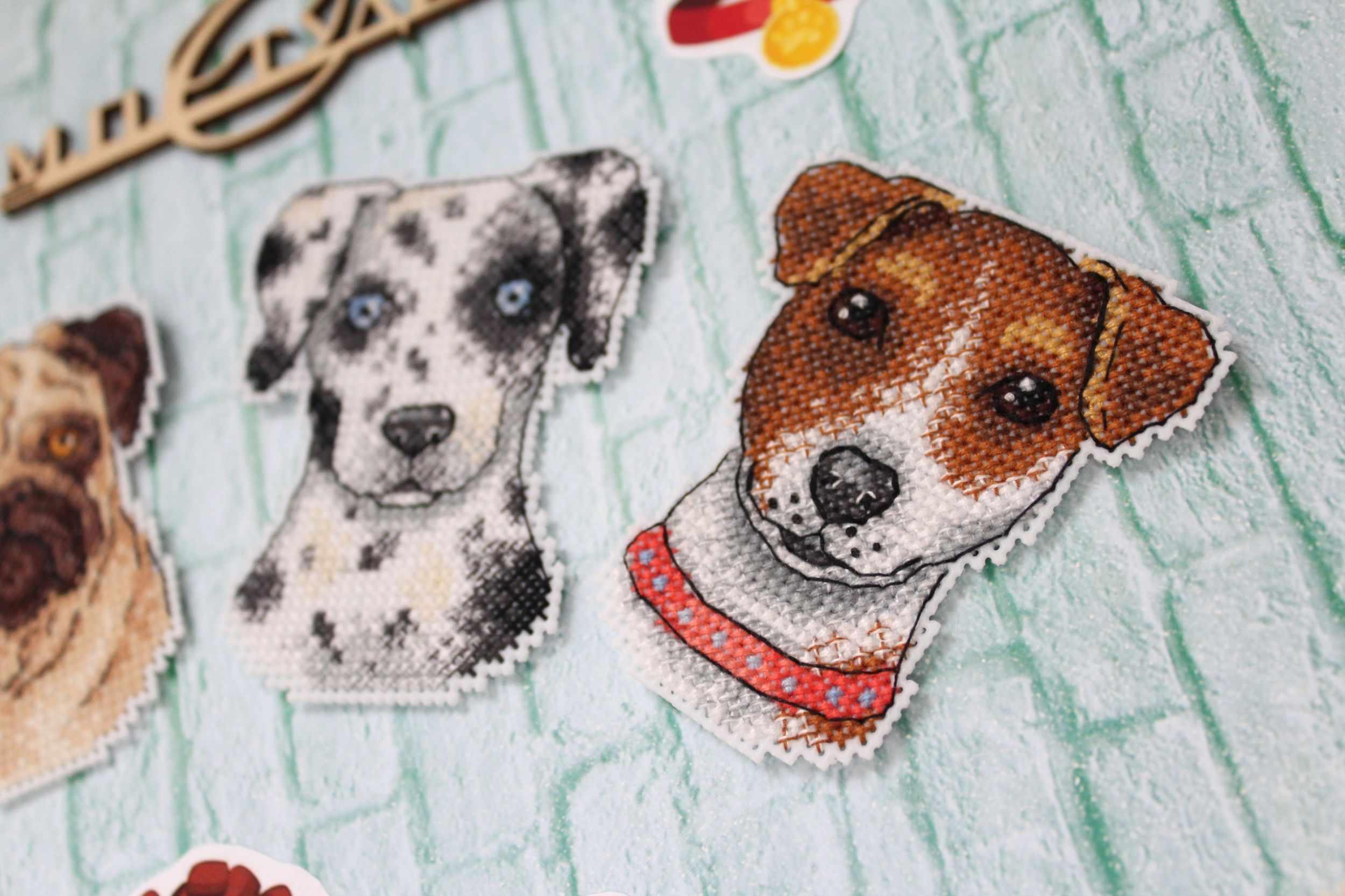 Who Said Woof? Magnets SR-409 Cross Stitch Kit featuring colorful threads, plastic canvas, and finished dog-themed magnets.