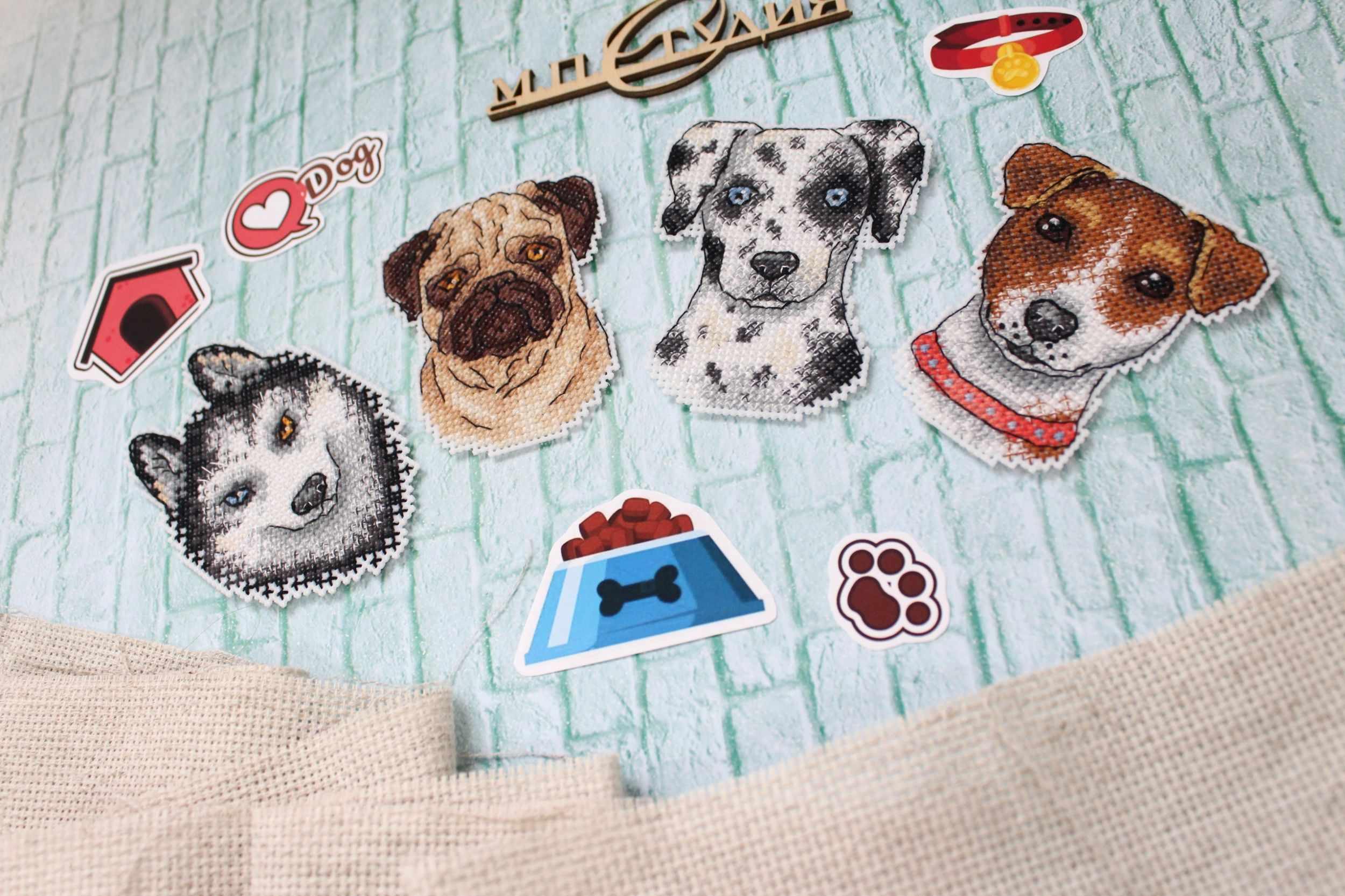 Who Said Woof? Magnets SR-409 Cross Stitch Kit featuring colorful threads, plastic canvas, and finished dog-themed magnets.