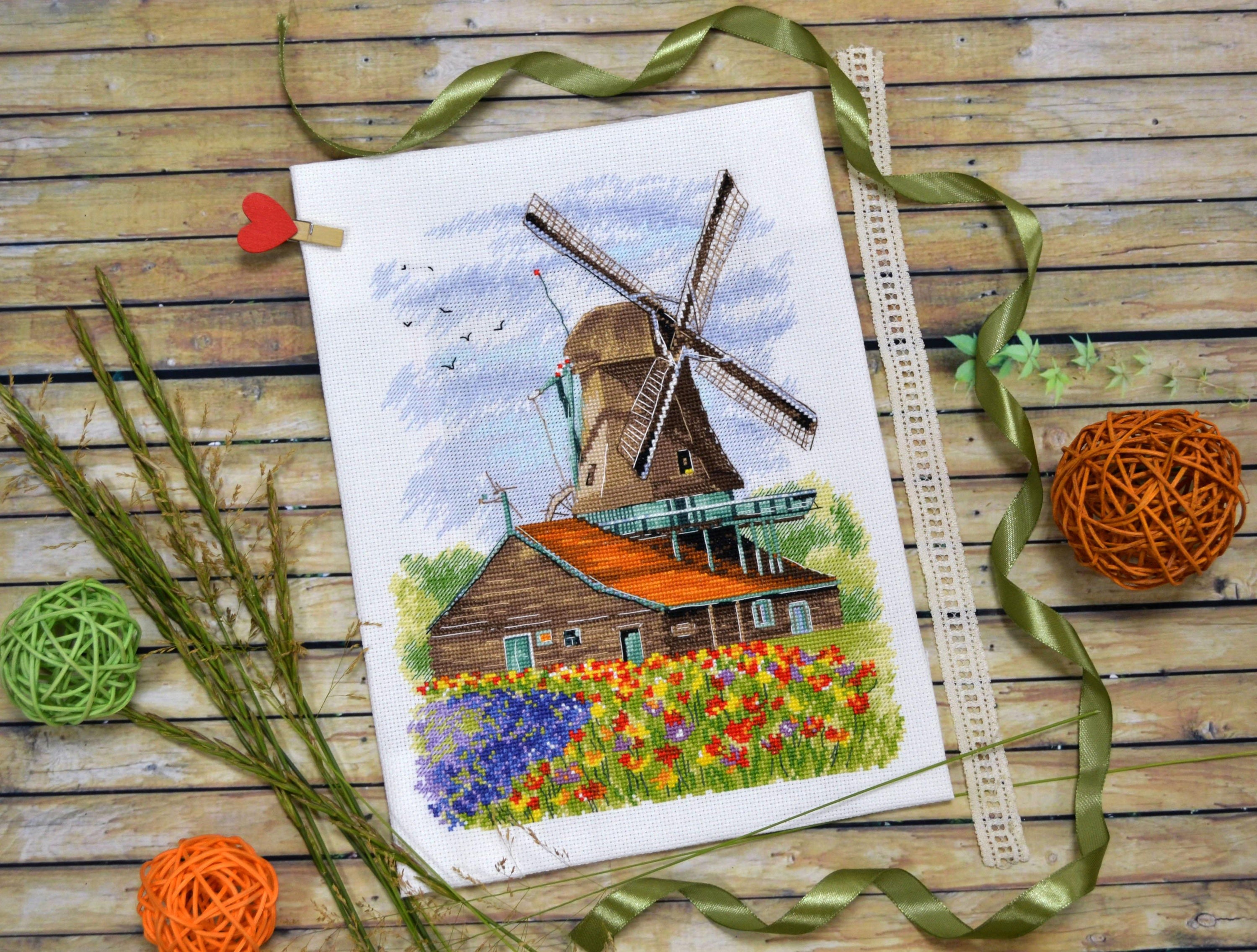 Windmill.Holland 1105 Counted Cross Stitch Kit with Aida canvas, colorful threads, and needle, showcasing a charming windmill design.