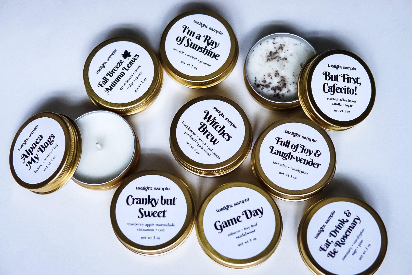 Winter Discovery Kit featuring 8 tea lights in gold tins, showcasing various fragrances for sampling.