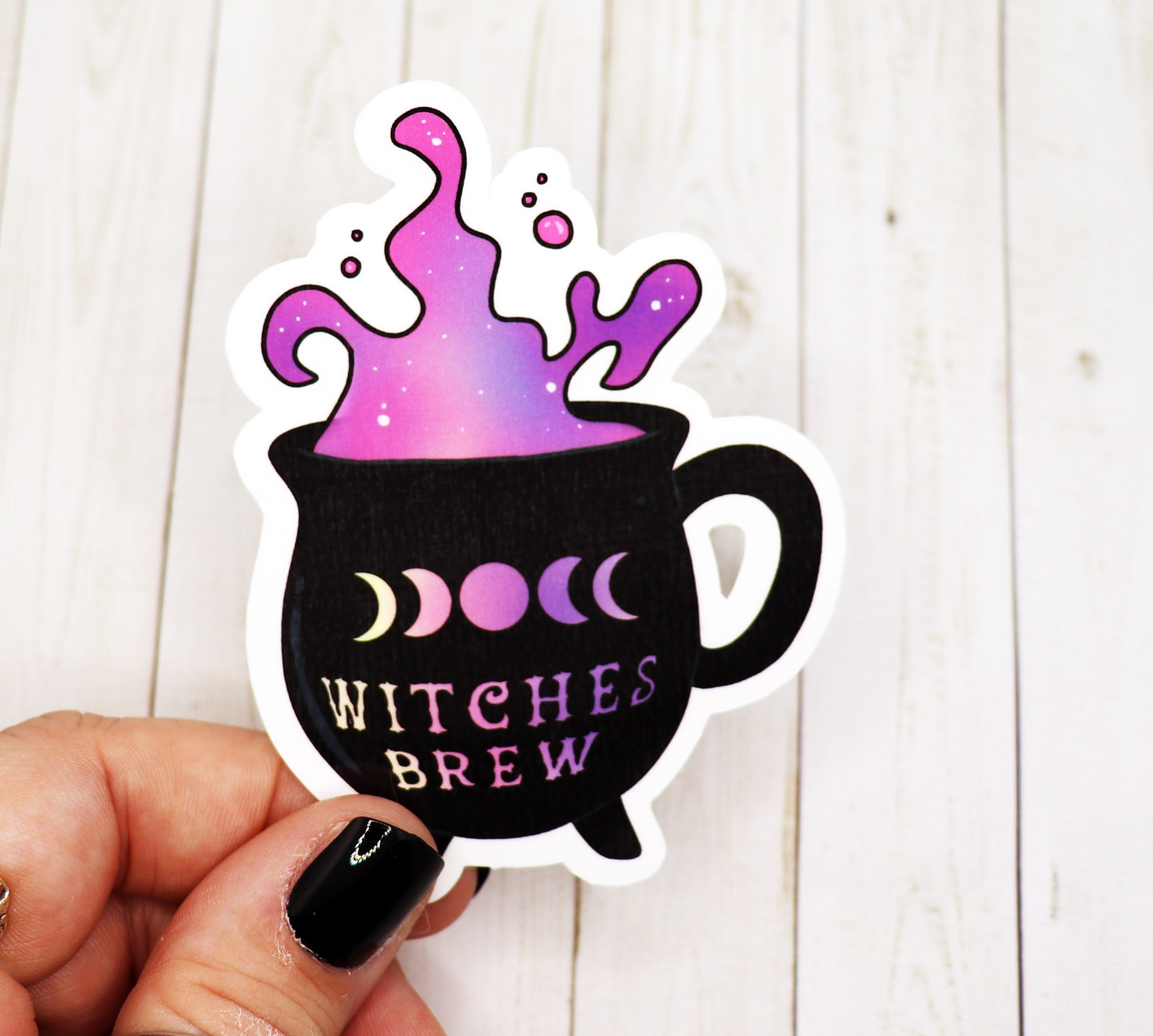 A whimsical Witches Brew Cauldron Mug Vinyl Sticker featuring a cauldron design, perfect for personalizing various items.