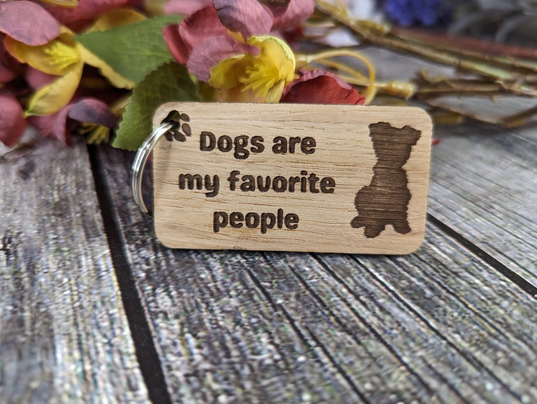 Eco-friendly wooden keyring with engraved message 'Dogs Are My Favourite People', crafted from sustainable wood.