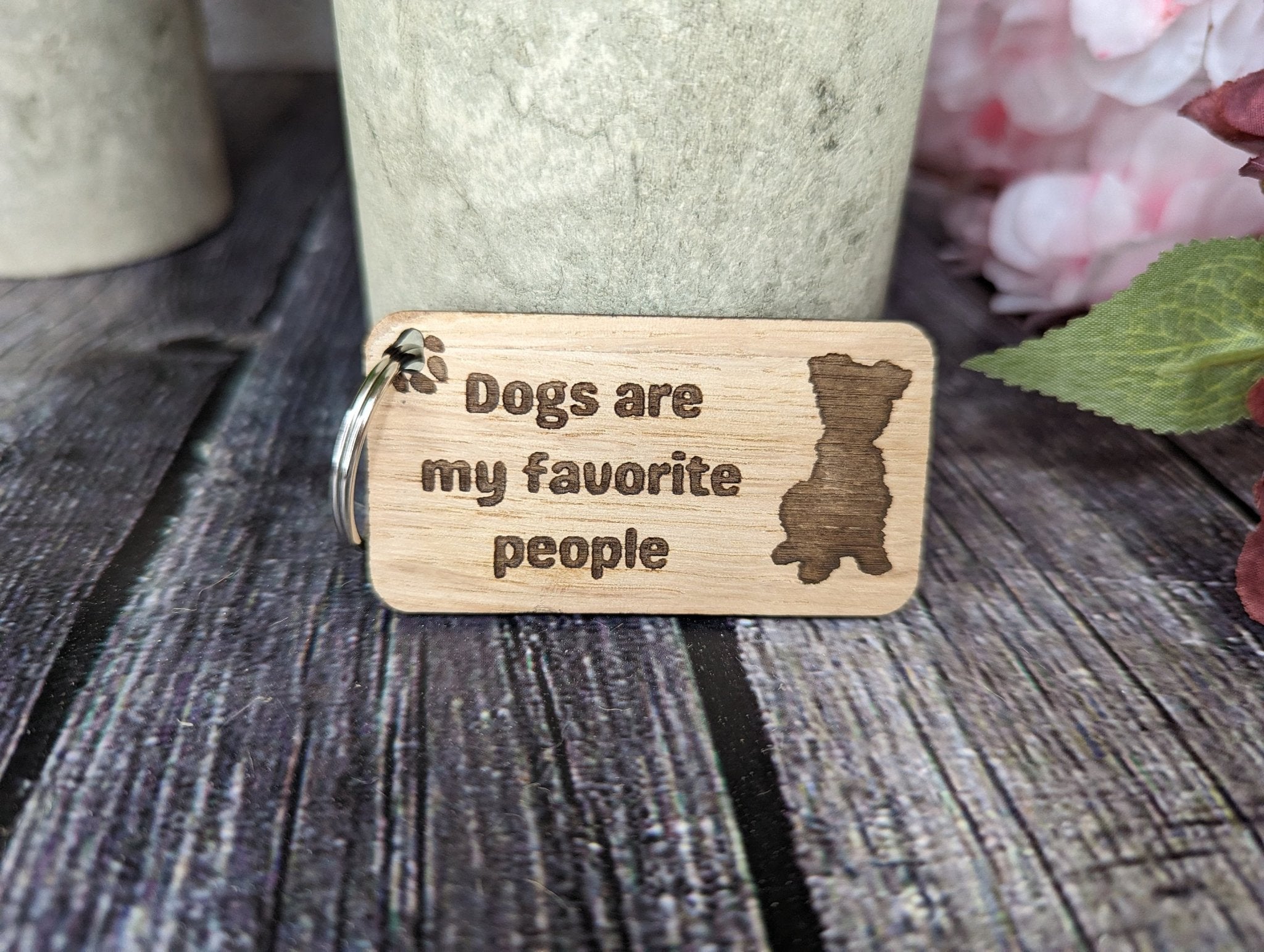 Eco-friendly wooden keyring with engraved message 'Dogs Are My Favourite People', crafted from sustainable wood.