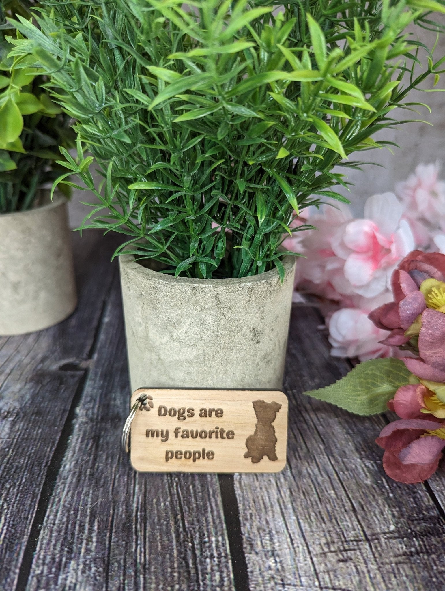 Eco-friendly wooden keyring with engraved message 'Dogs Are My Favourite People', crafted from sustainable wood.