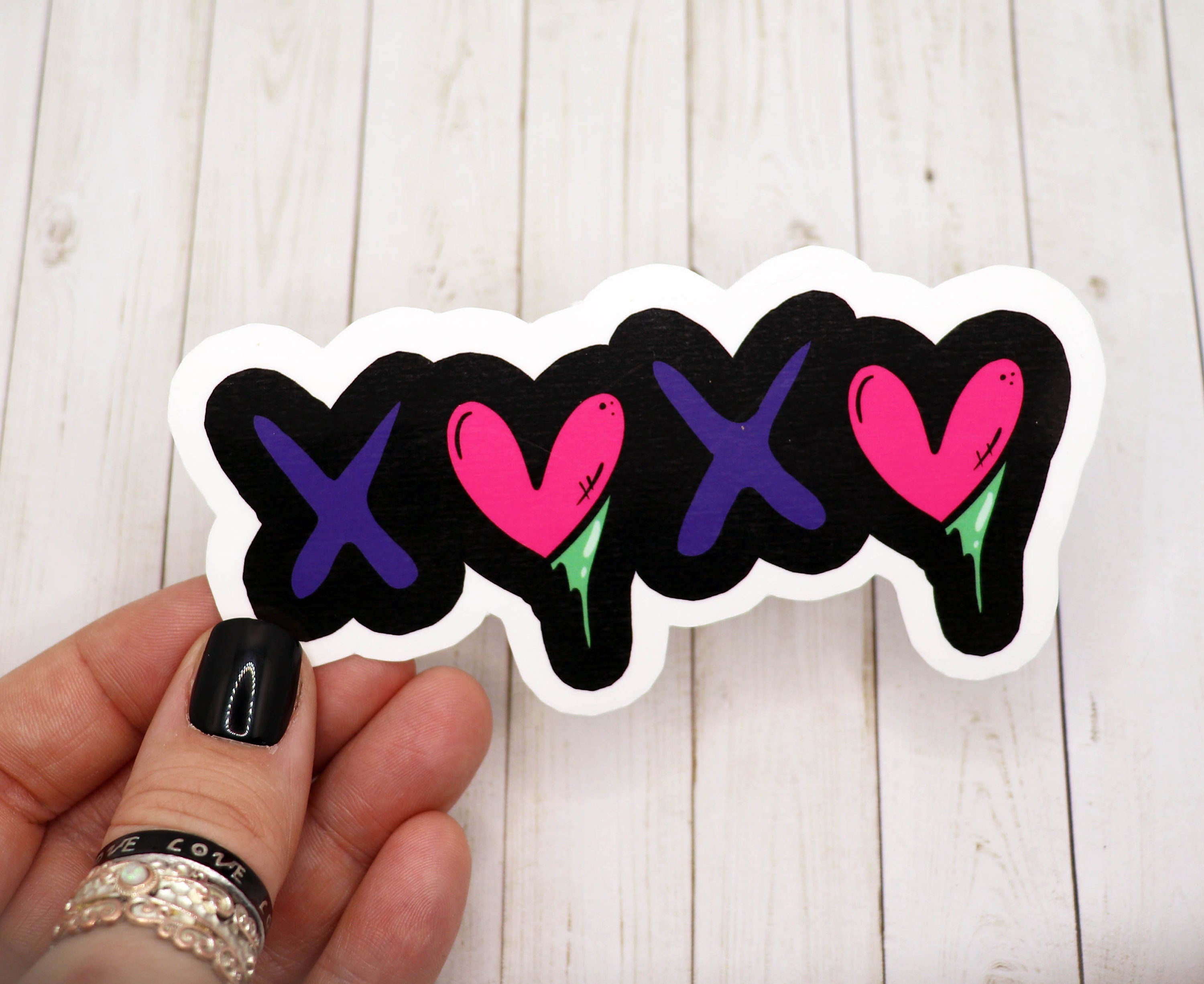 A stylish XOXO vinyl sticker on a white background, showcasing its matte finish and vibrant design.