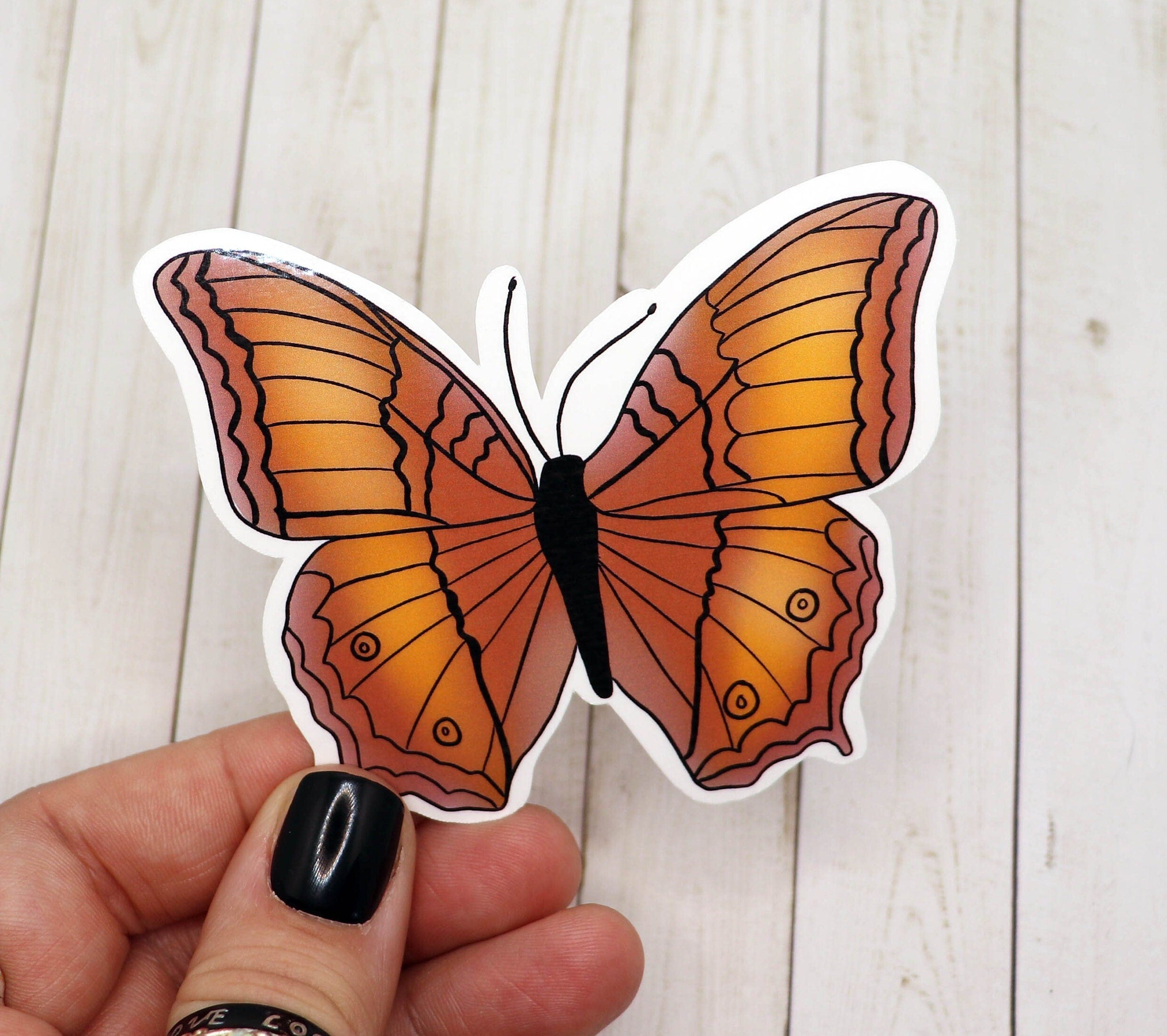 A vibrant yellow butterfly sticker on a white background, showcasing its intricate design and matte finish.