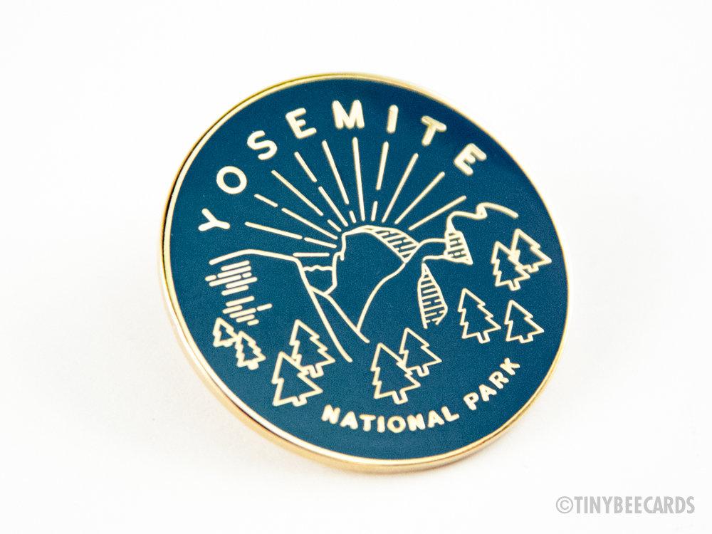 Yosemite National Park enamel pin featuring a colorful illustration and gold metal finish.