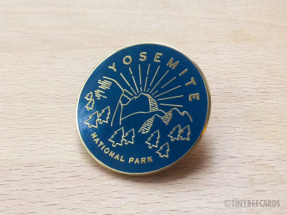 Yosemite National Park enamel pin featuring a colorful illustration and gold metal finish.