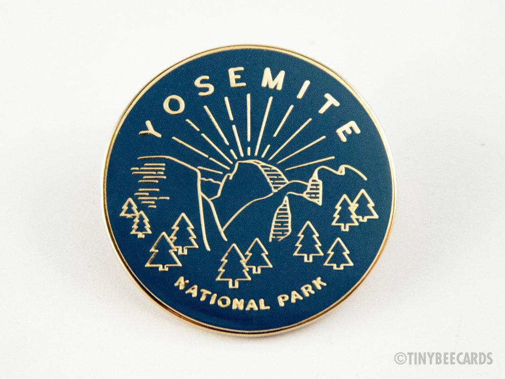 Yosemite National Park enamel pin featuring a colorful illustration and gold metal finish.