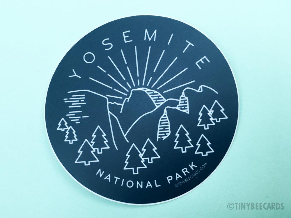 A vibrant vinyl sticker featuring Yosemite National Park illustration with navy blue background and text.