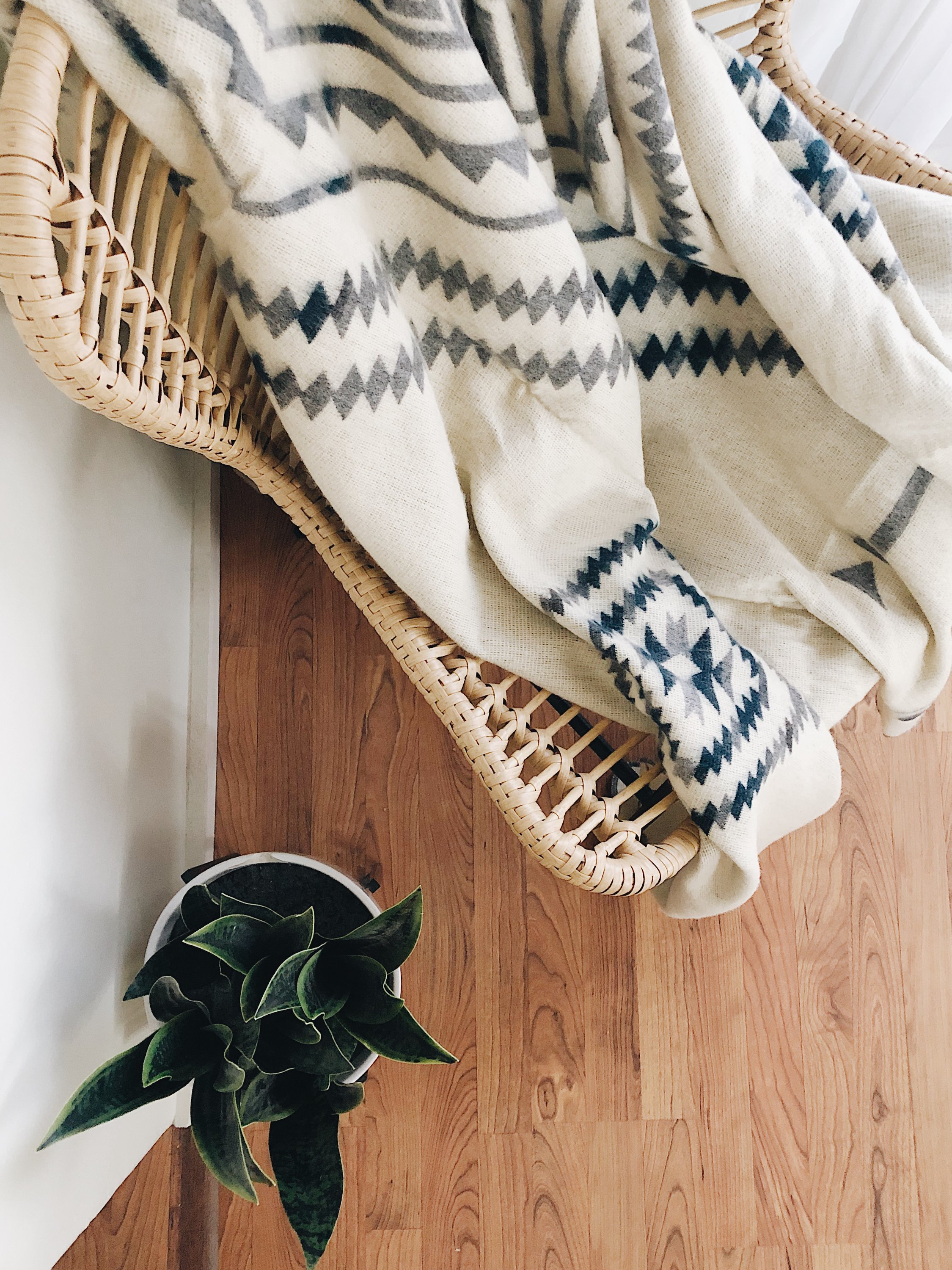 Achuar Blanket in Ash Grey, showcasing its soft texture and reversible design, perfect for cozying up indoors or outdoor adventures.