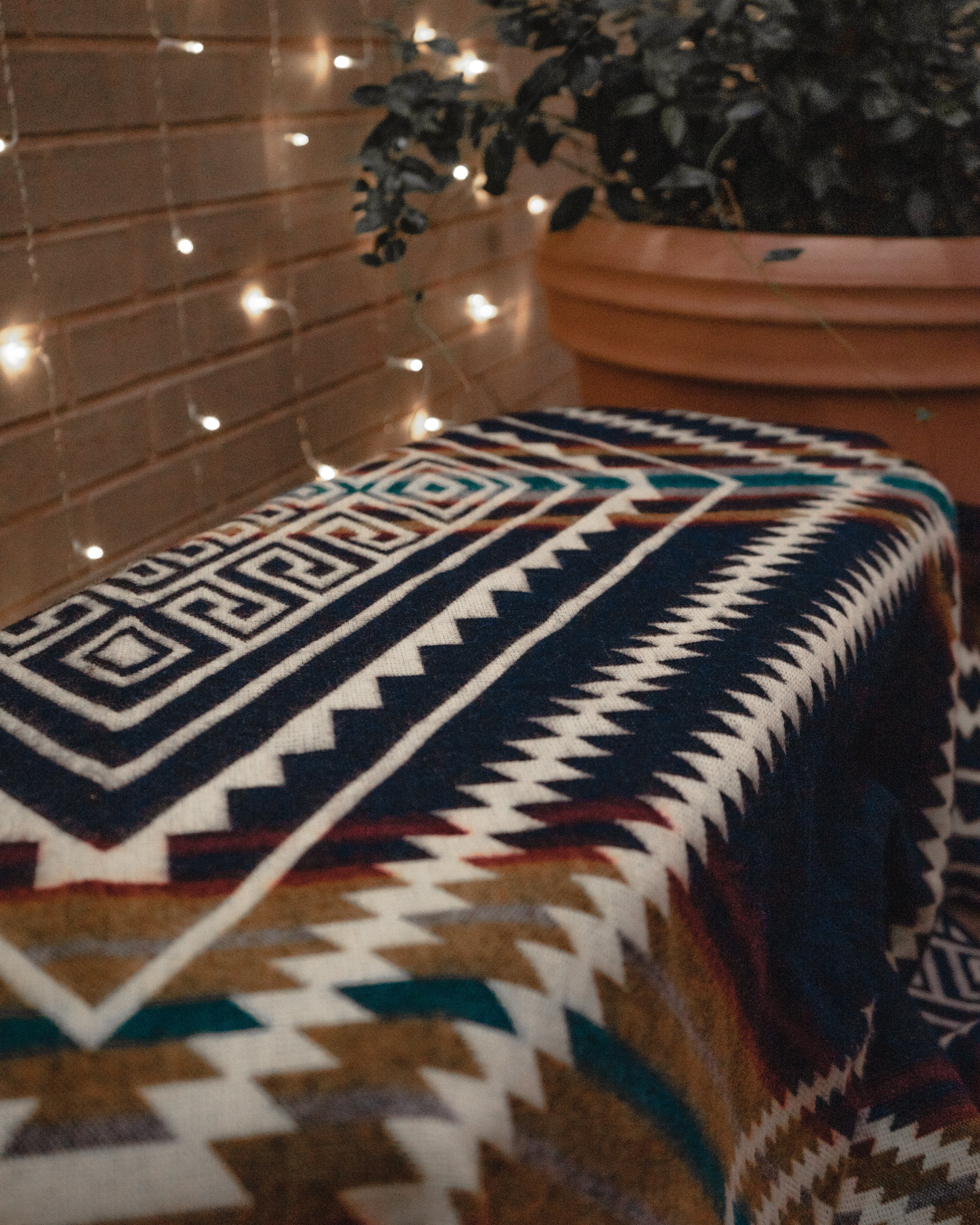 Achuar Blanket in Dark Navy, handcrafted from recycled acrylic, showcasing reversible colors and a cozy design, perfect for indoor and outdoor use.