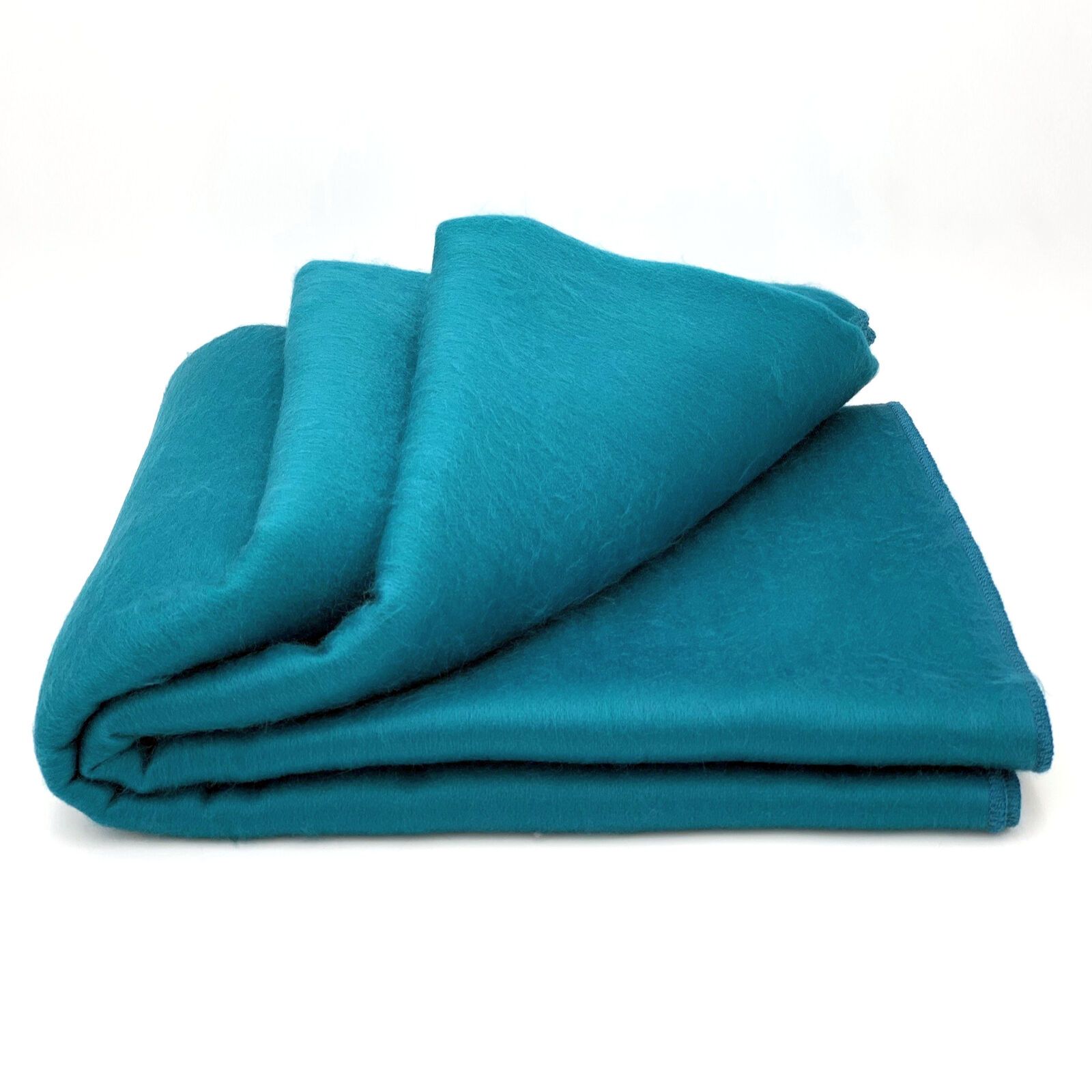 Cozy alpaca bed blanket in various colors, showcasing its soft texture and luxurious feel.