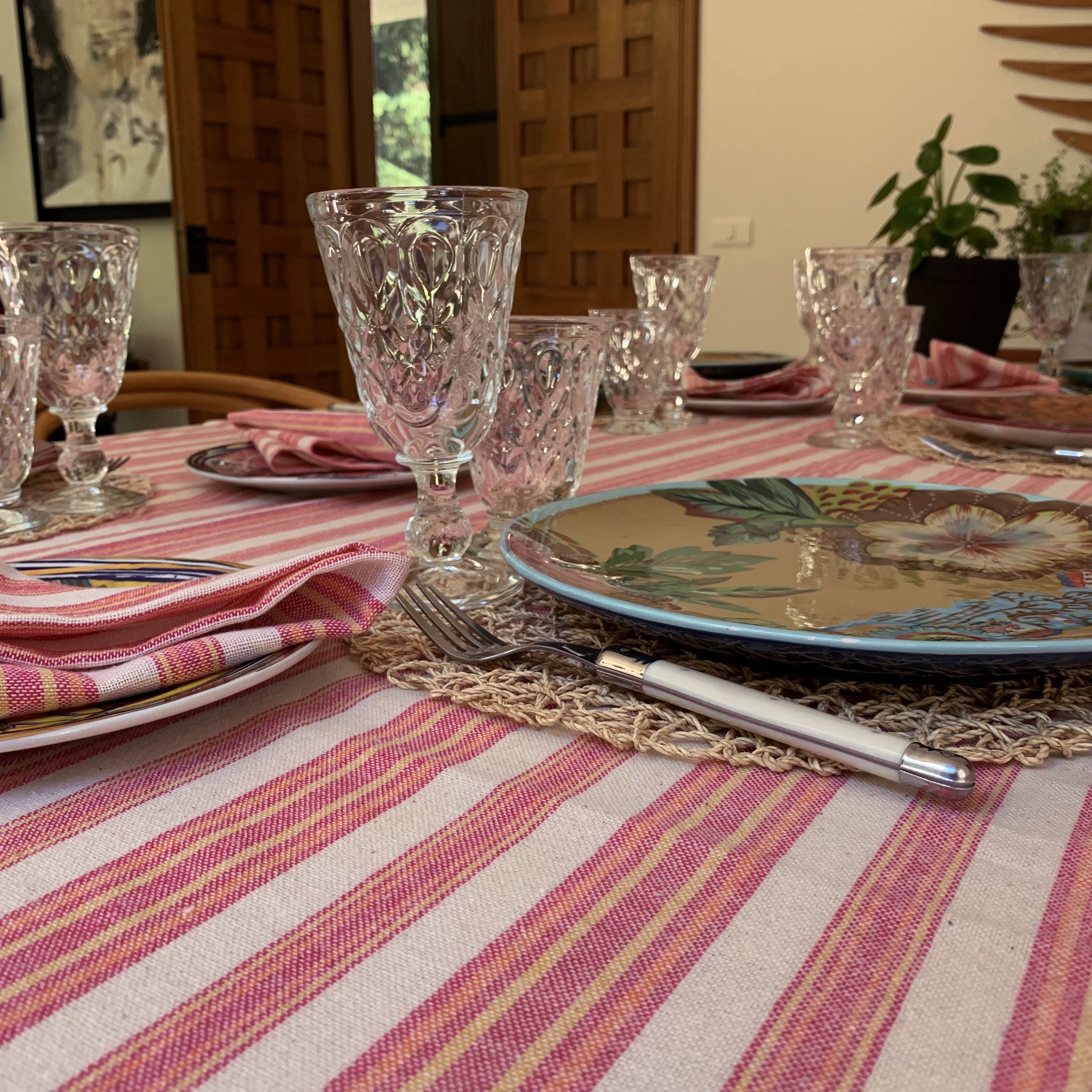 Andana Striped Tablecloth Set in Magenta with matching napkins, showcasing eco-friendly design and stylish stripes.