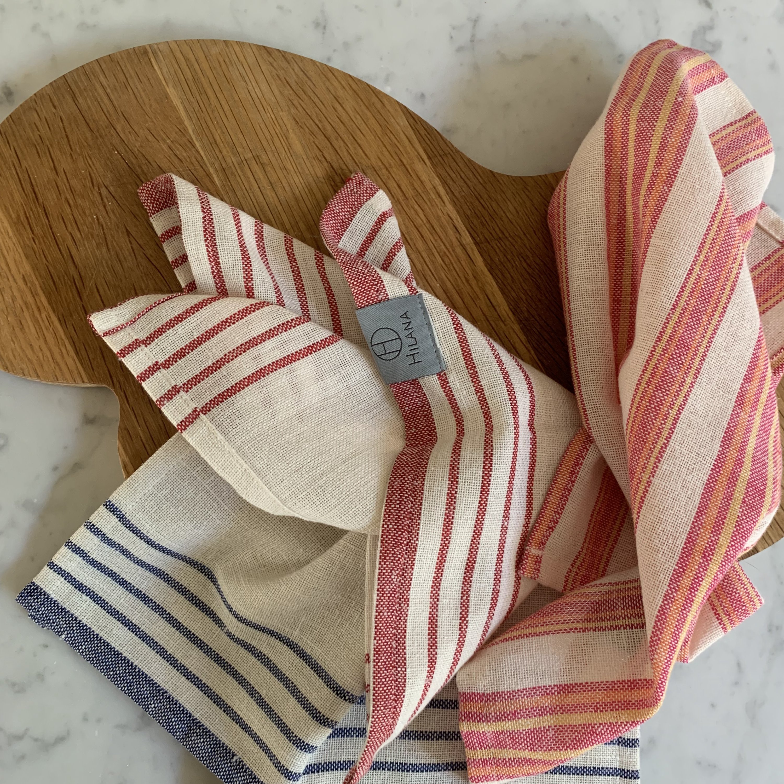 Andana Striped Tablecloth Set in Magenta with matching napkins, showcasing eco-friendly design and stylish stripes.