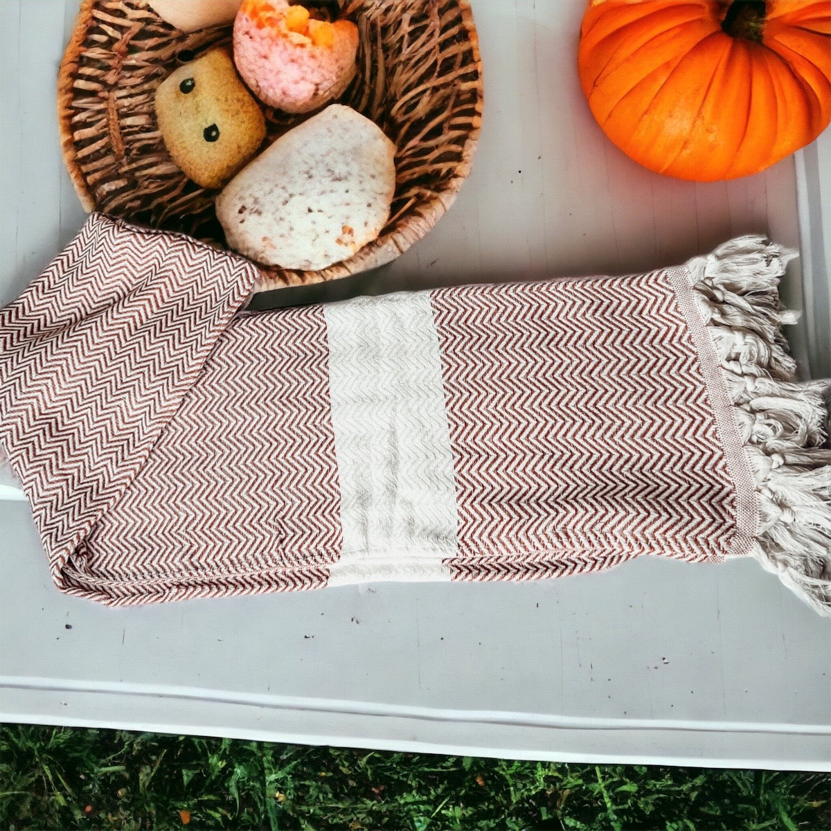 Chevron Towel made from 200 GSM Turkish cotton, featuring decorative tassels and available in blue, gray, and rust colors.