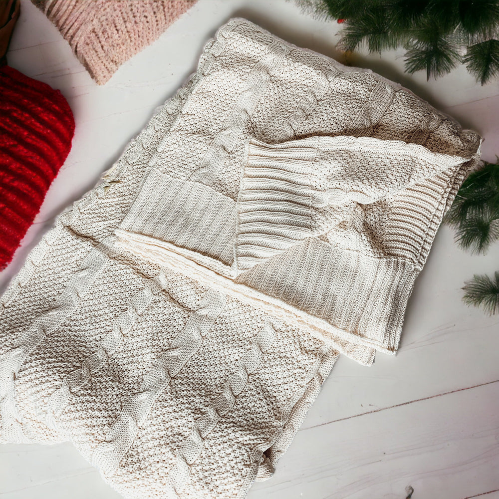 Cozy Claret Knit Sweater Throw blanket draped elegantly on a couch, showcasing its rich color and soft texture.