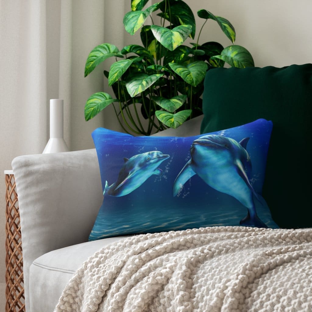 Decorative lumbar throw pillow featuring a blue dolphin design, made from spun-polyester fabric with a hidden zipper.