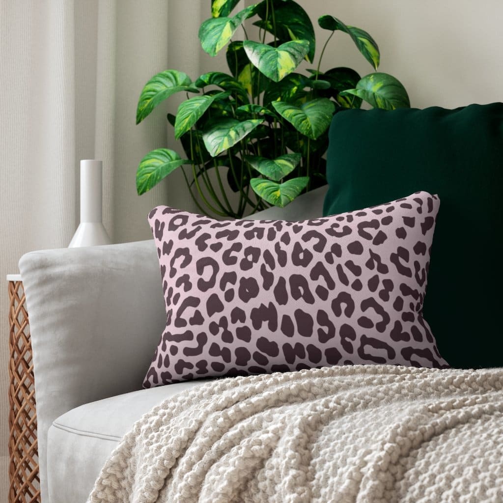 Decorative lumbar throw pillow featuring a stylish leopard print in pink and black, with a concealed zipper and removable insert.