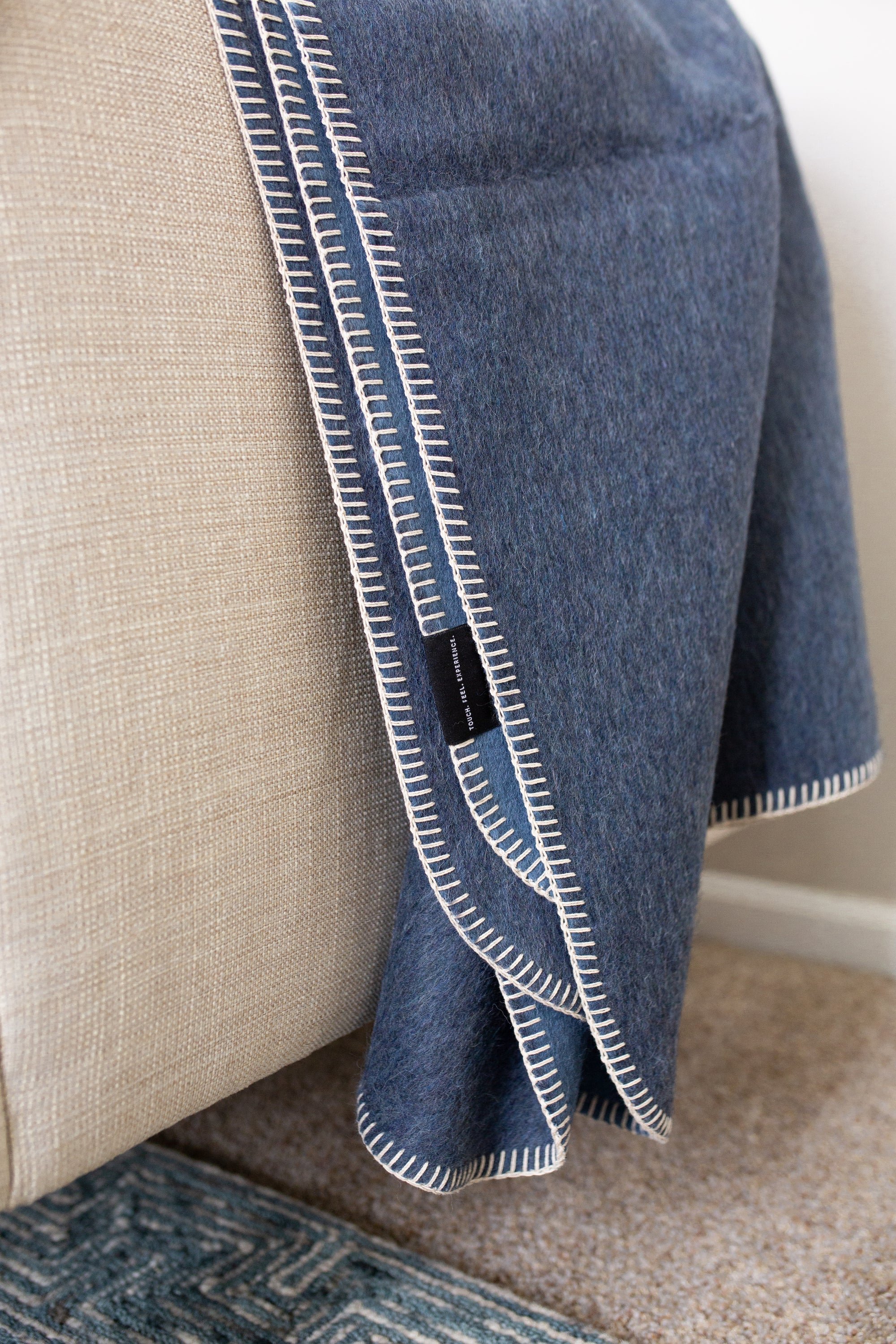 Descanso Alpaca Blend Throw in Navy Heather, showcasing its soft texture and elegant design, perfect for home decor.