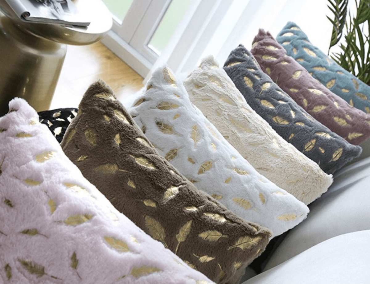 Dixie Plush pillows featuring soft velvet fabric and hand-painted gold decals, perfect for home decor.