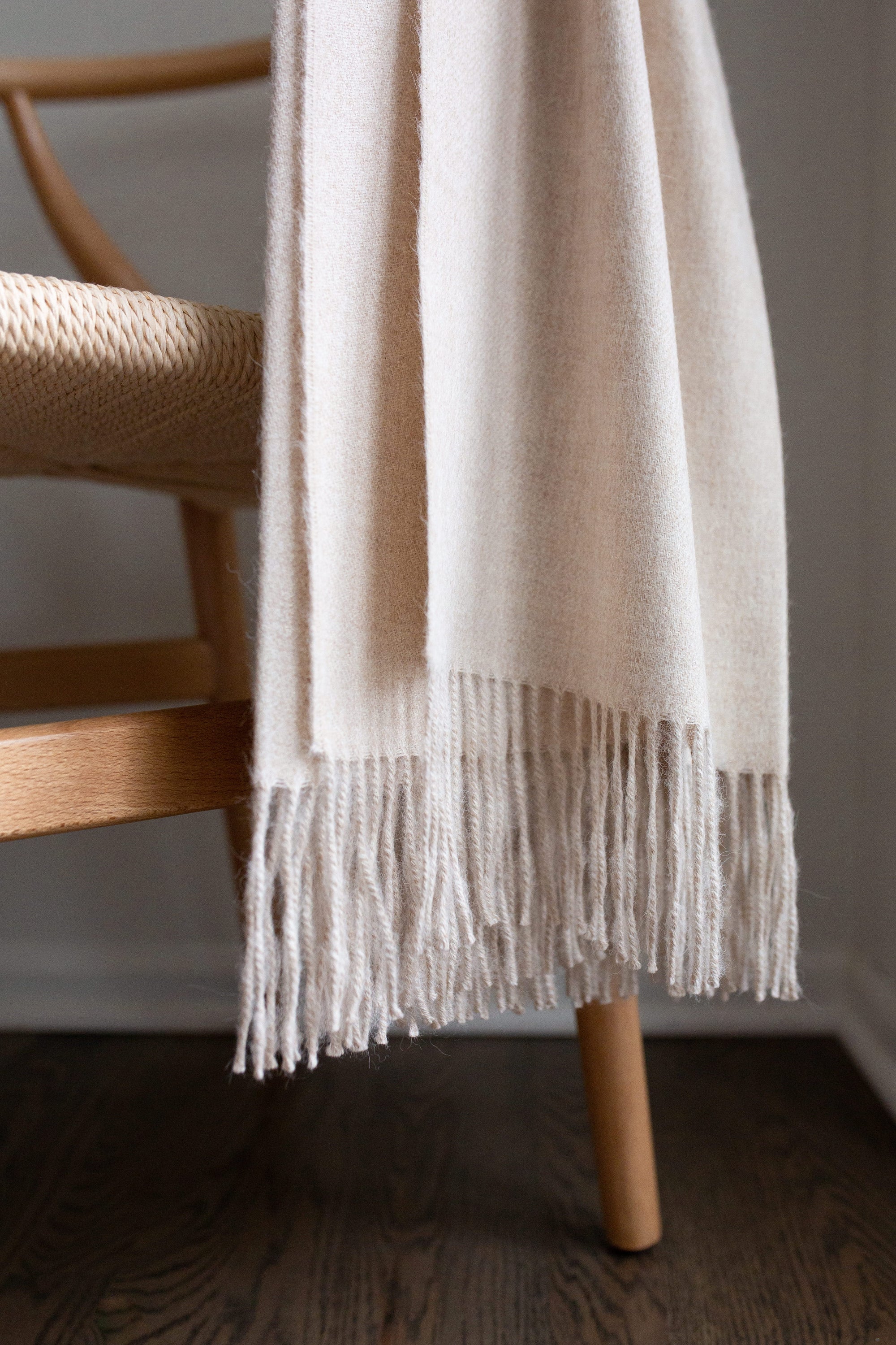 Encanto Alpaca Throw in Alabaster, showcasing its soft texture and elegant design, perfect for home decor.