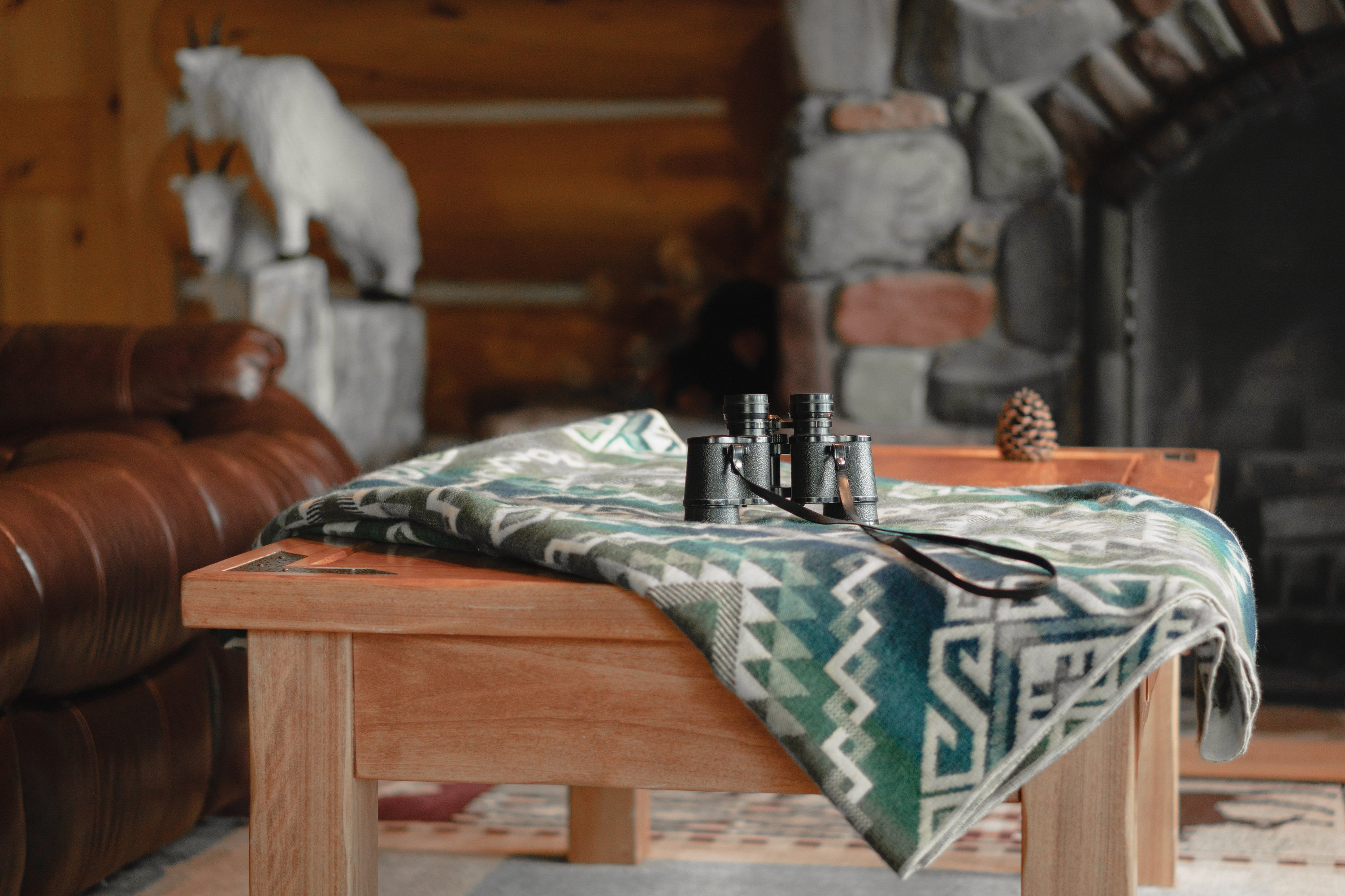 Epera Blanket in blue and green, showcasing its soft texture and reversible design, handcrafted by Ecuadorian artisans.