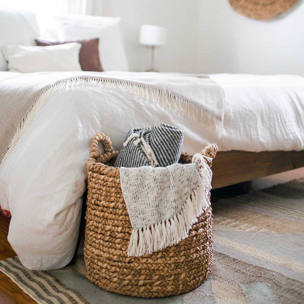 Heathered Gray Alpaca Throw draped elegantly on a sofa, showcasing its luxurious texture and neutral colors.