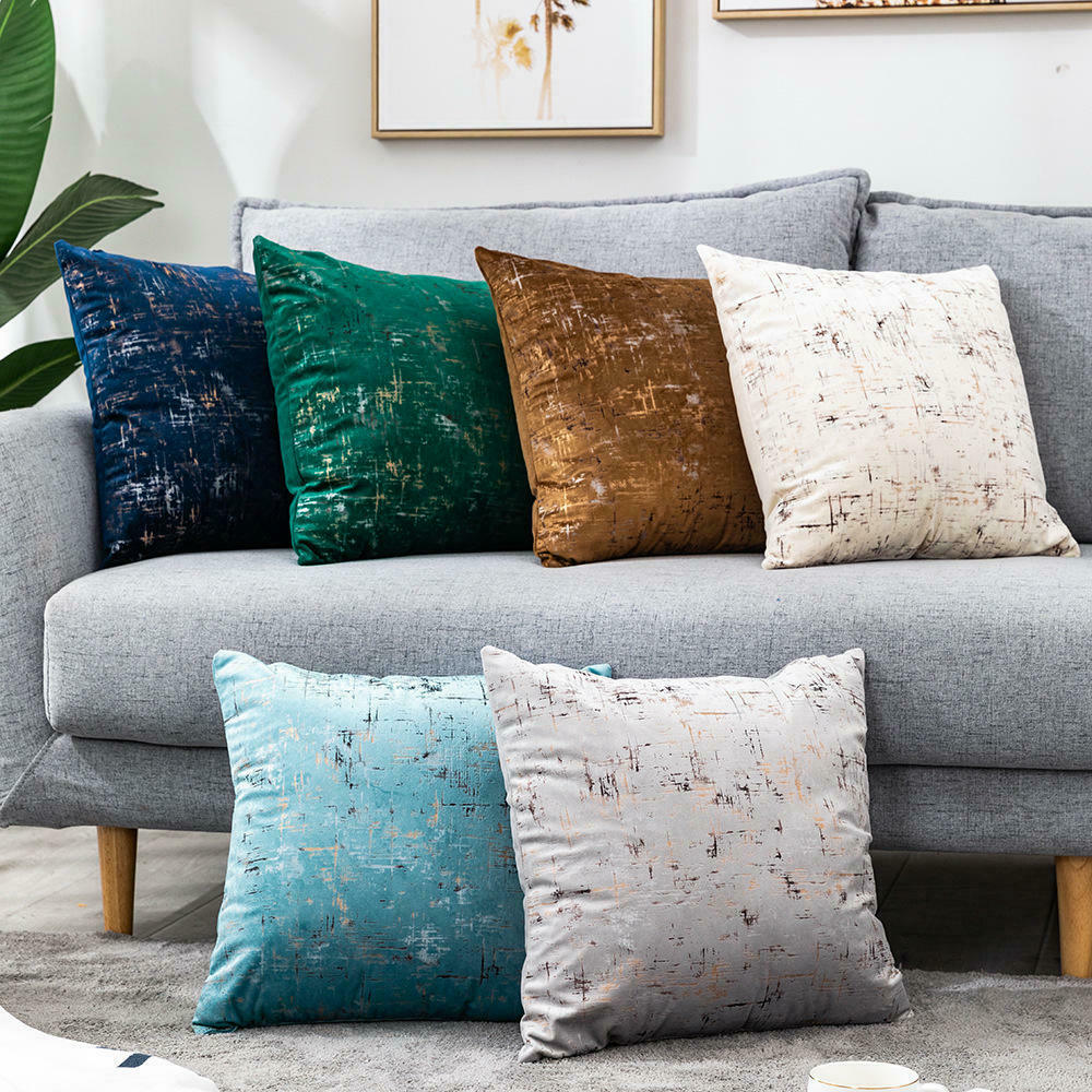 Light blue velvet cushion cover with gold geometric stamping, showcasing a luxurious design suitable for various home decor styles.