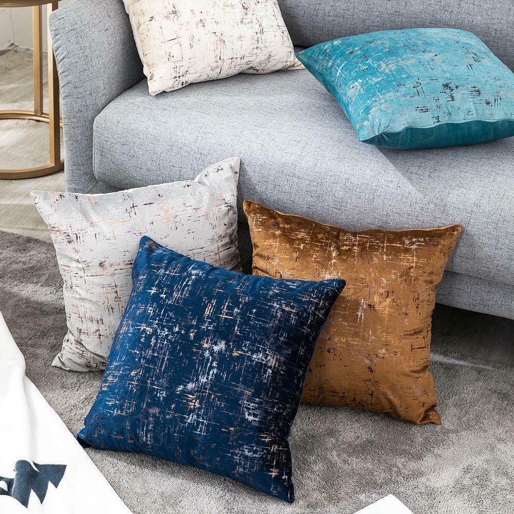 Light blue velvet cushion cover with gold geometric stamping, showcasing a luxurious design suitable for various home decor styles.