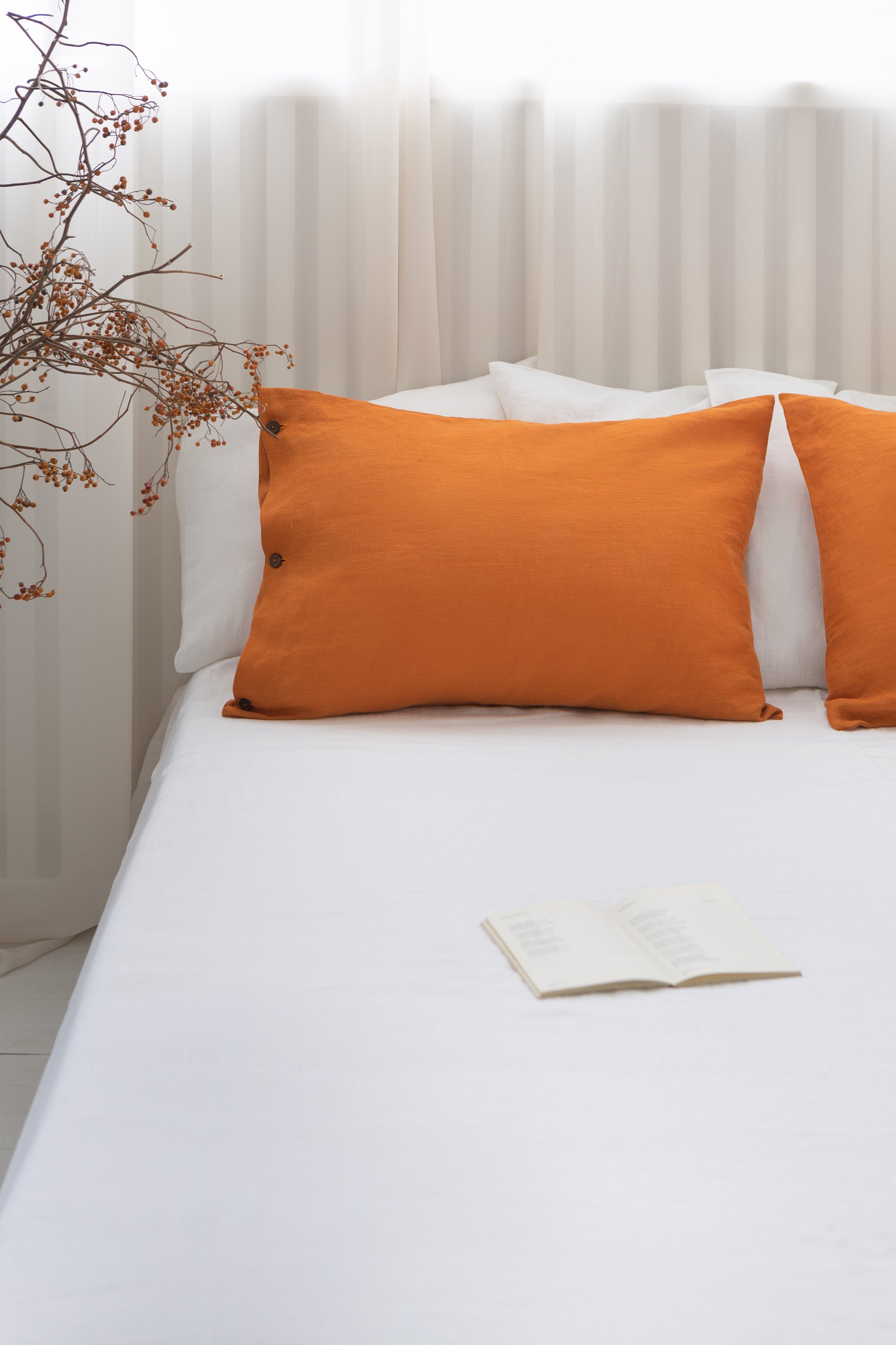 Elegant linen pillow cases with envelope closure, showcasing soft texture and natural fabric in various colors.