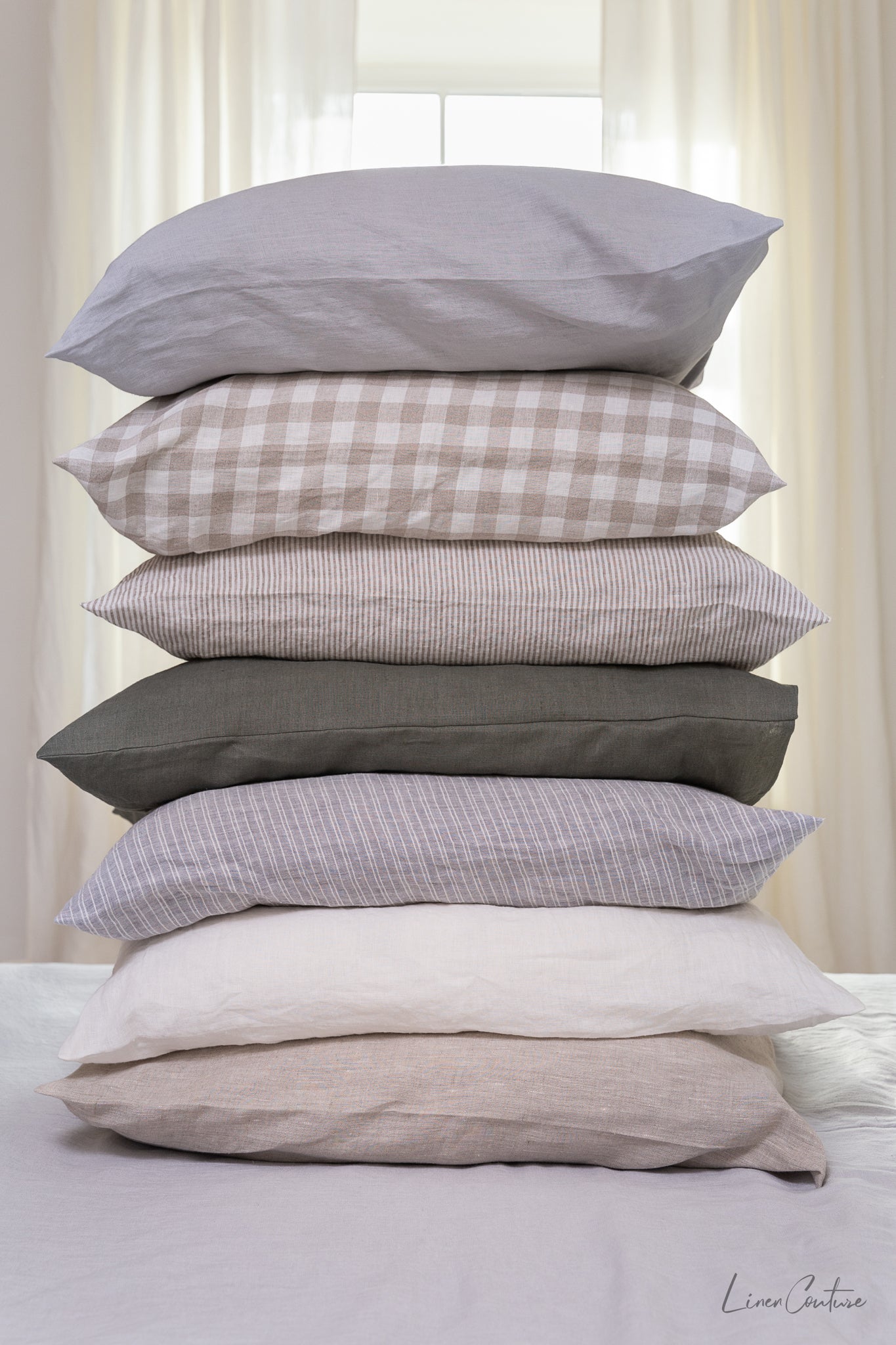 Elegant linen pillow cases with envelope closure, showcasing soft texture and natural fabric in various colors.