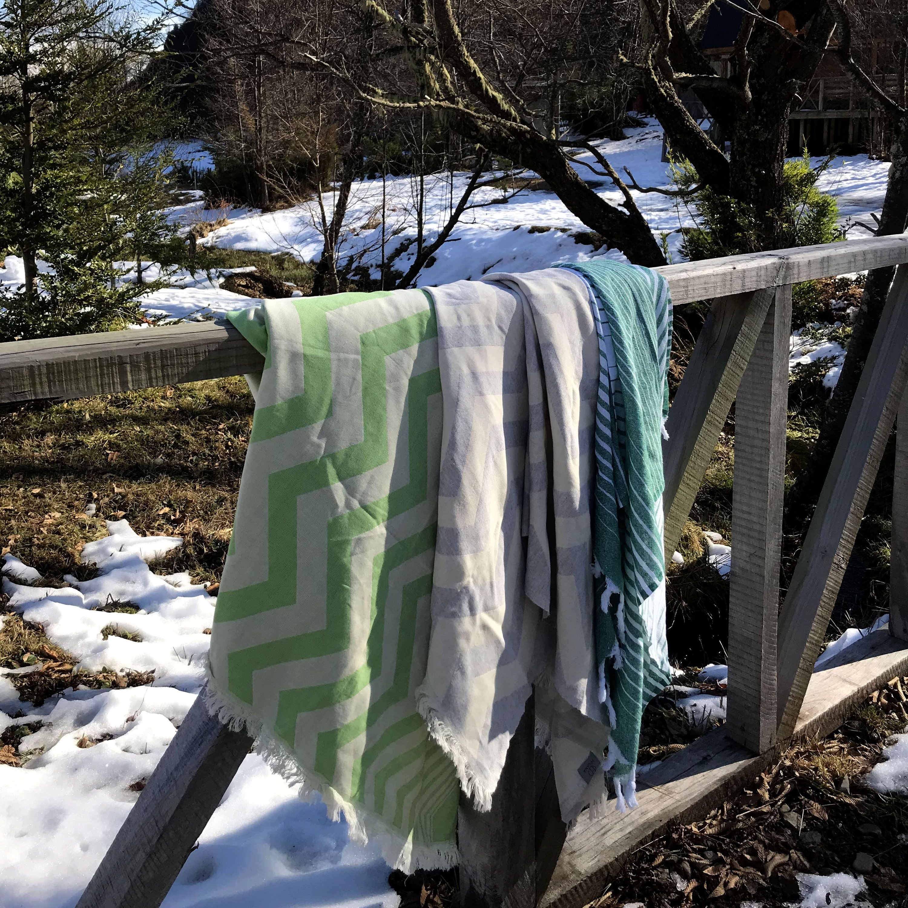 Mersin Chevron Towel in bright green with a chevron pattern, showcasing its soft texture and handcrafted tassels.