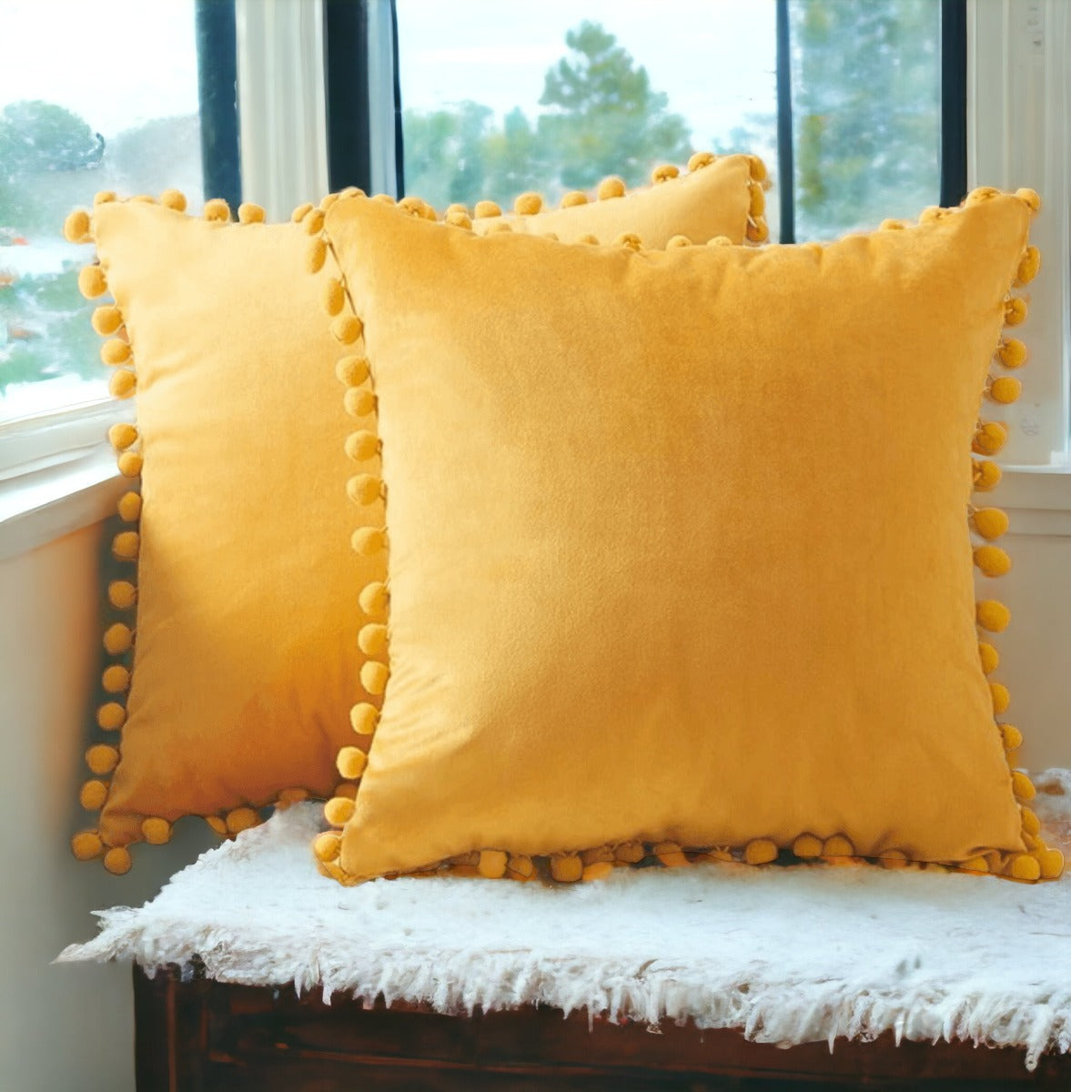 A cozy set of Plush Pom Poms pillows in soft velour material, perfect for cuddling or decorative use.