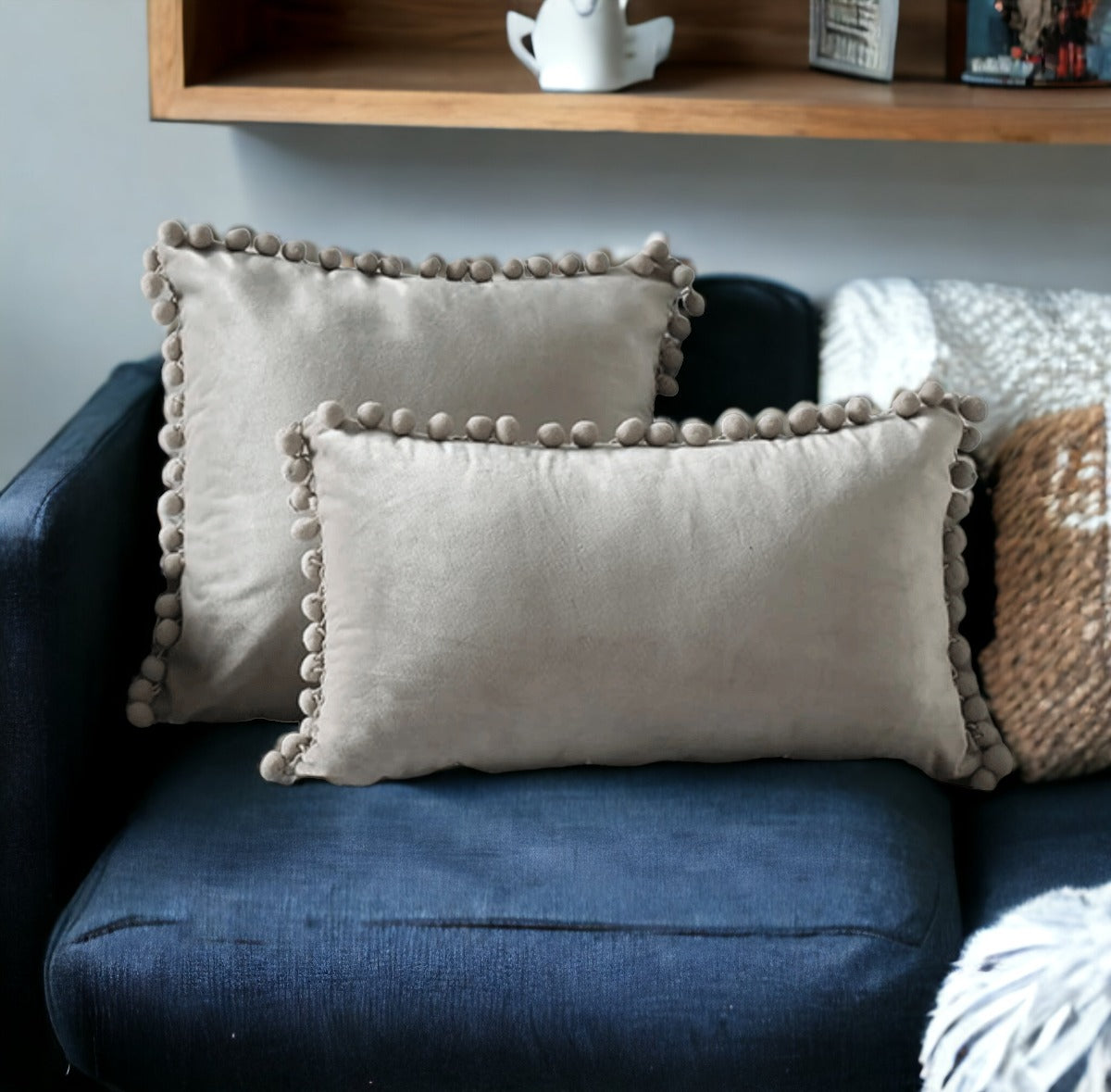 A cozy set of Plush Pom Poms pillows in soft velour material, perfect for cuddling or decorative use.