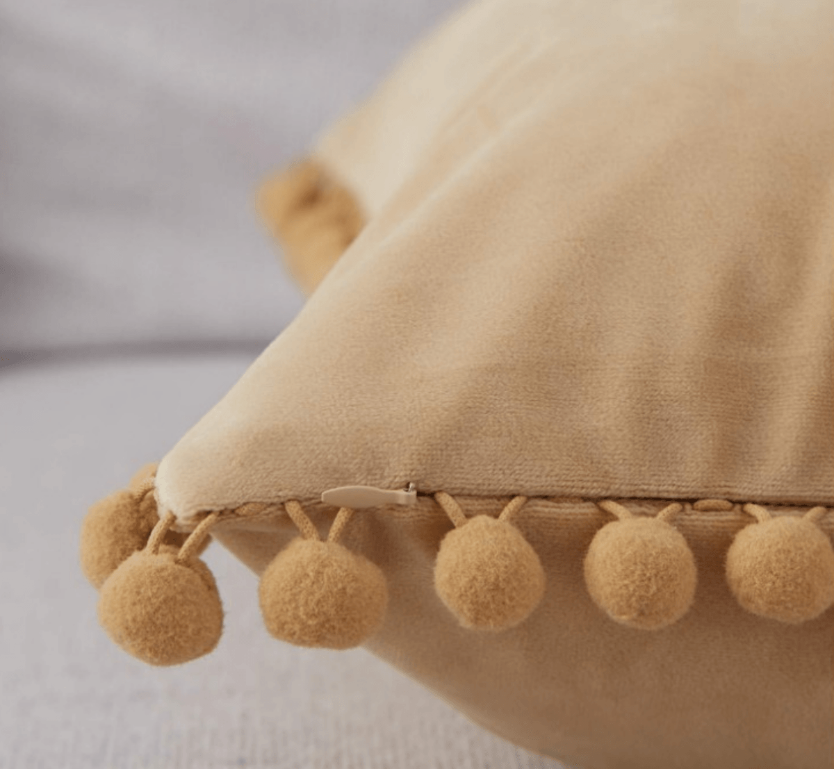 A cozy set of Plush Pom Poms pillows in soft velour material, perfect for cuddling or decorative use.