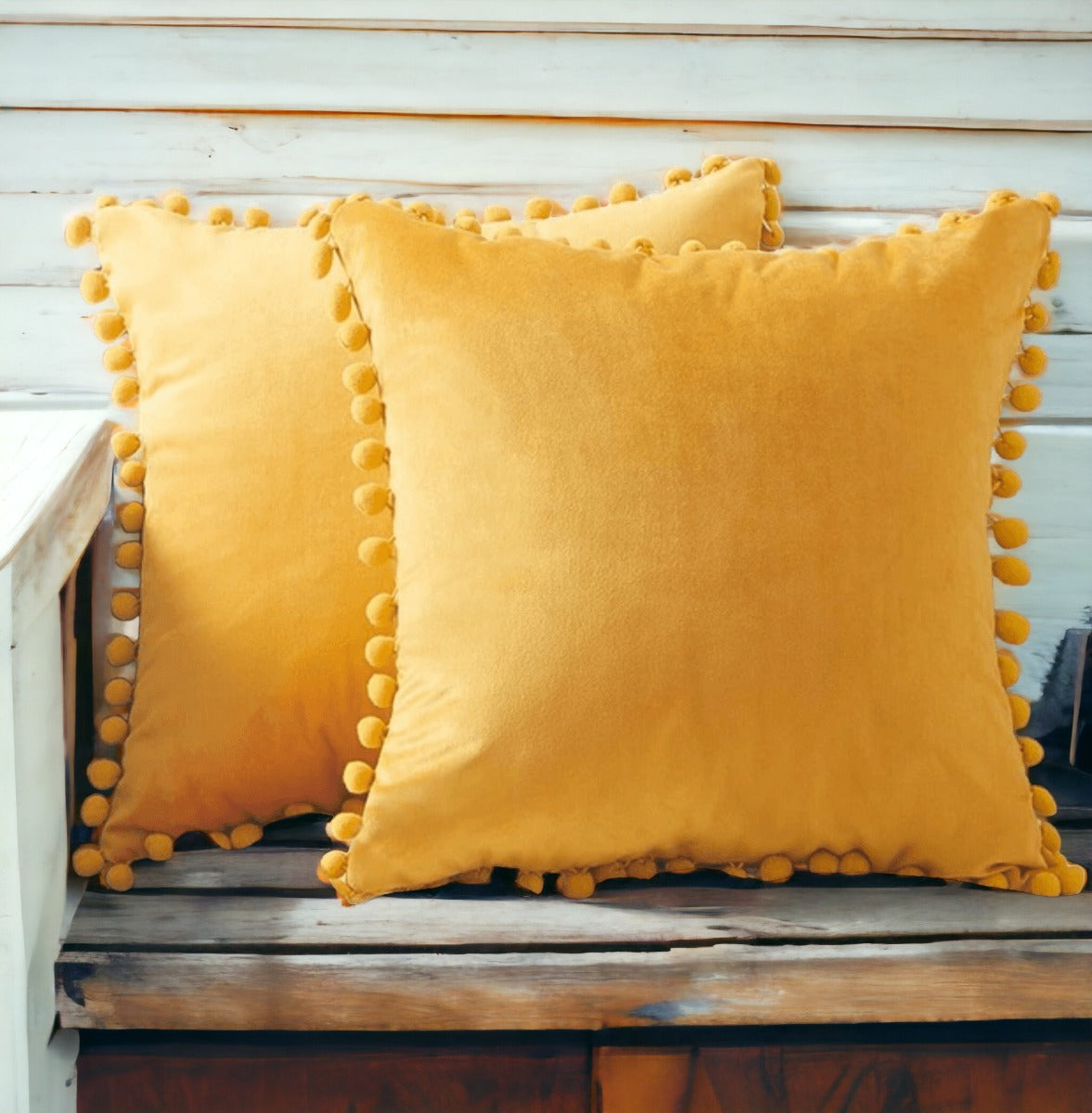 A cozy set of Plush Pom Poms pillows in soft velour material, perfect for cuddling or decorative use.