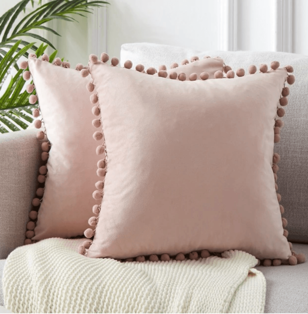 A cozy set of Plush Pom Poms pillows in soft velour material, perfect for cuddling or decorative use.