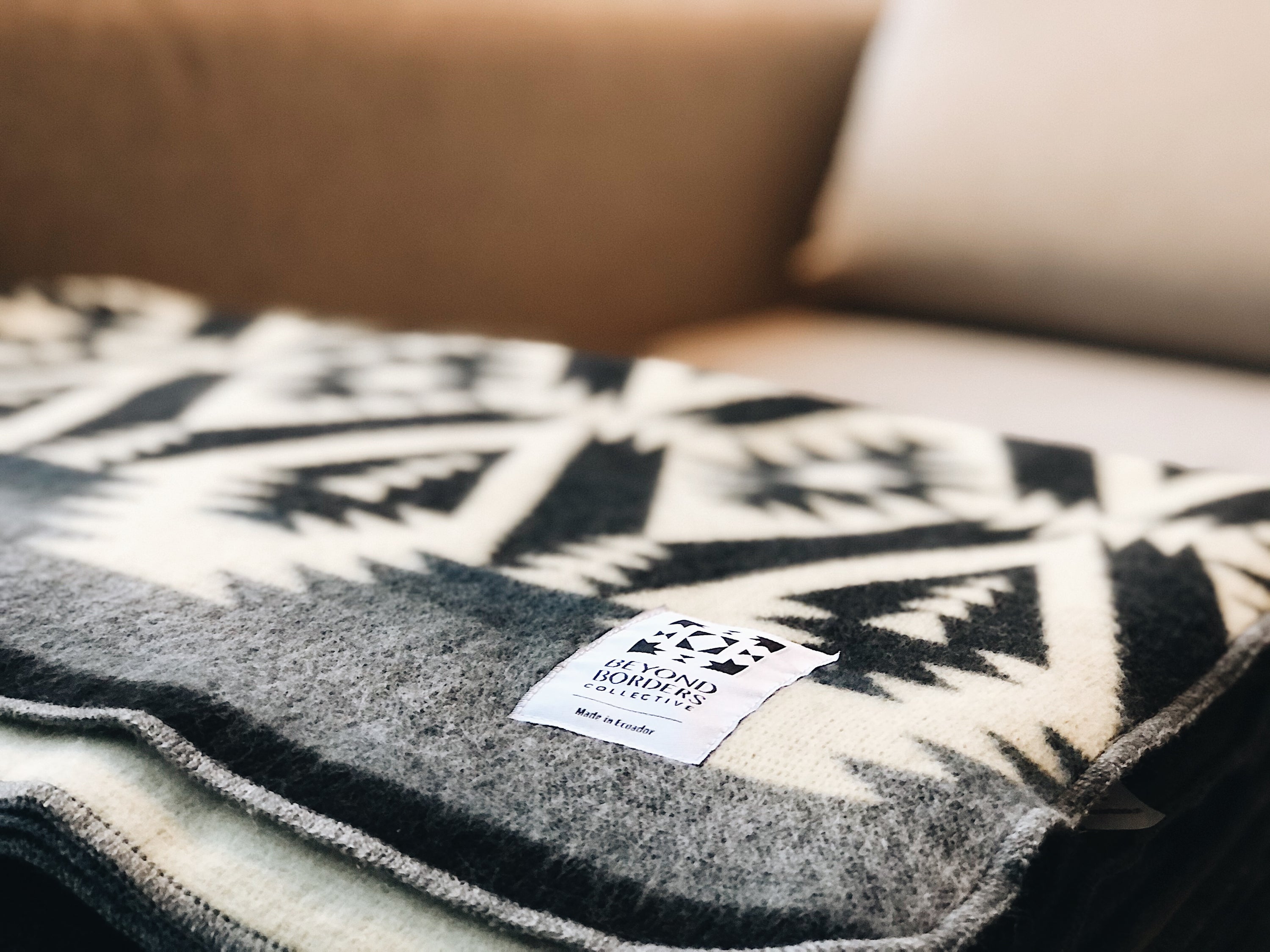 Quichua Blanket in greyscale, showcasing its soft texture and reversible design, handcrafted by Ecuadorian artisans.