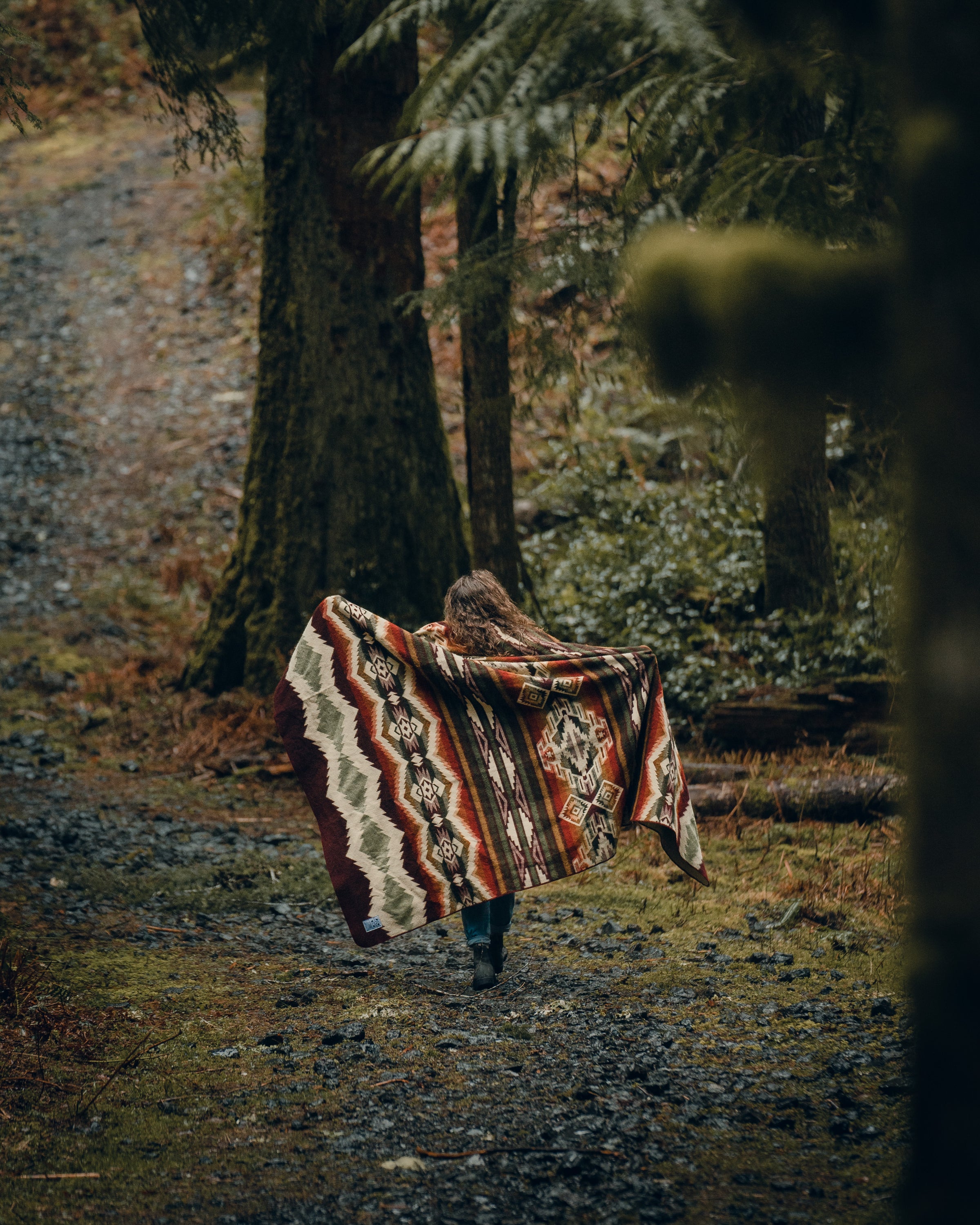 Spondylus Blanket in Plum with vibrant accent colors, showcasing its soft texture and cultural design.