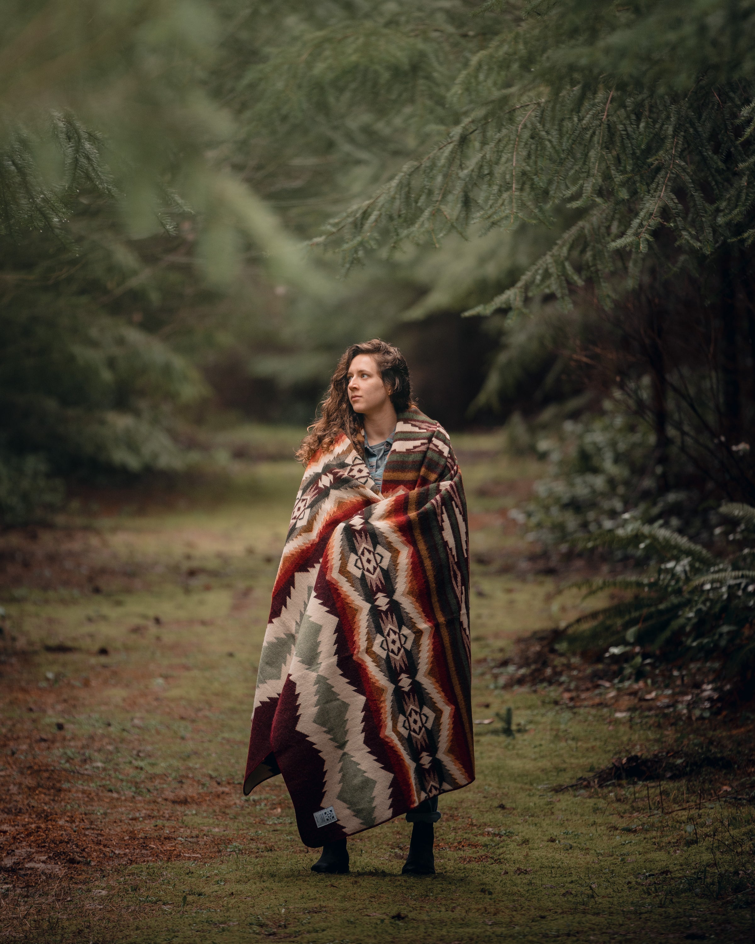 Spondylus Blanket in Plum with vibrant accent colors, showcasing its soft texture and cultural design.