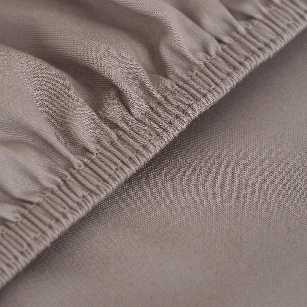 A Twill Fitted Sheet showcasing its durable twill weave and non-slip rubber backing, available in various colors.