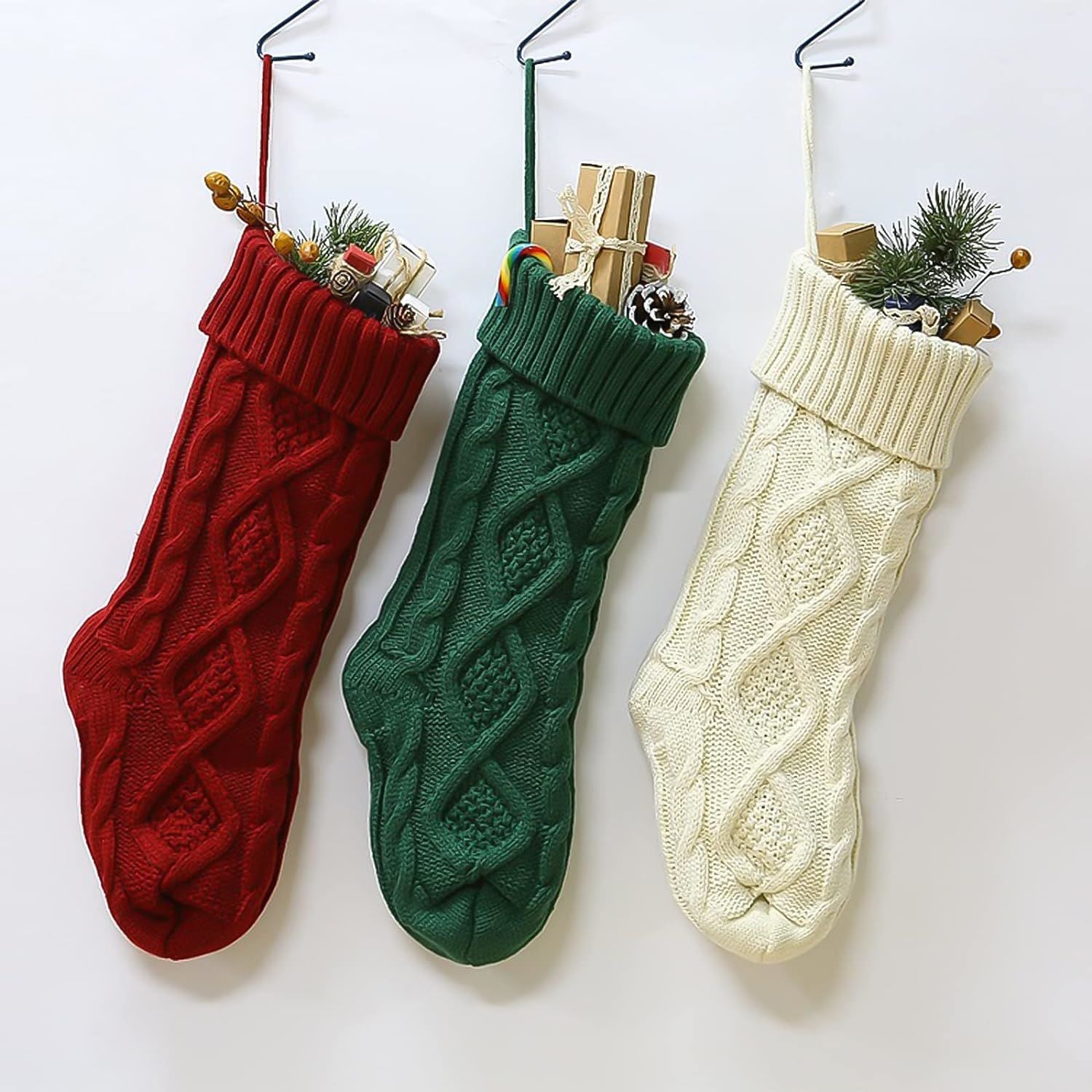 Three large knitted Christmas stockings in red, white, and green, each measuring 18 inches, displayed with festive patterns and hanging loops.