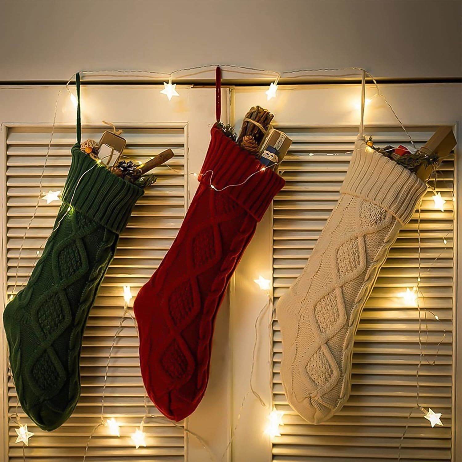 Three large knitted Christmas stockings in red, white, and green, each measuring 18 inches, displayed with festive patterns and hanging loops.