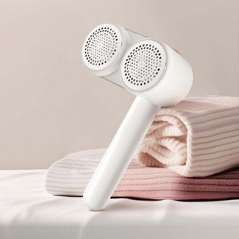 Rechargeable double head lint remover for clothes, featuring dual heads and a sleek design, ideal for removing lint and hairballs from various fabrics.