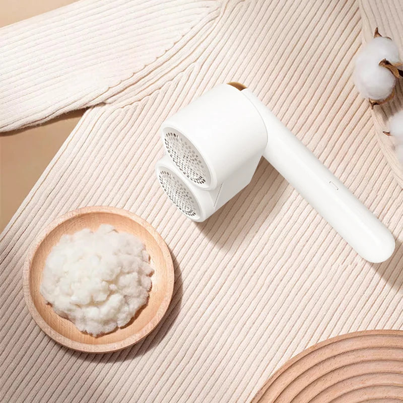 Rechargeable double head lint remover for clothes, featuring dual heads and a sleek design, ideal for removing lint and hairballs from various fabrics.