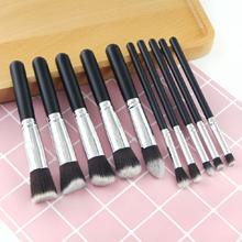 Mini Makeup Brushes Set for Travel featuring 10 professional brushes in a chic black design with golden accents and wooden handles.