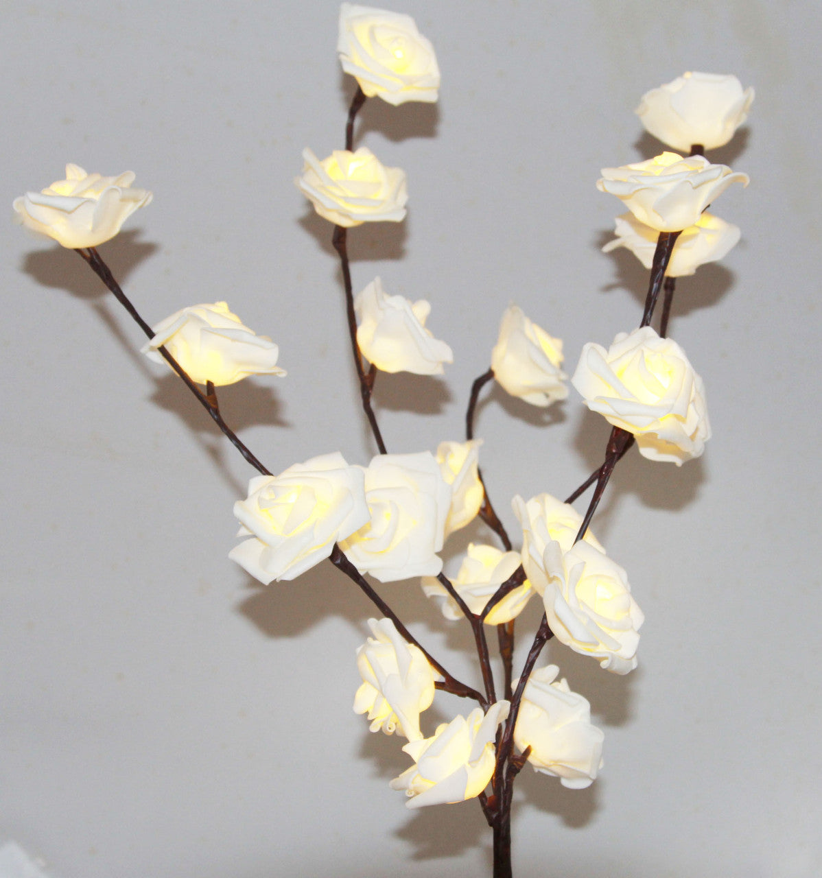 A beautiful 50cm high LED White Rose Tree Branch Fairy Light with 20 delicate white roses, perfect for weddings and home decor.