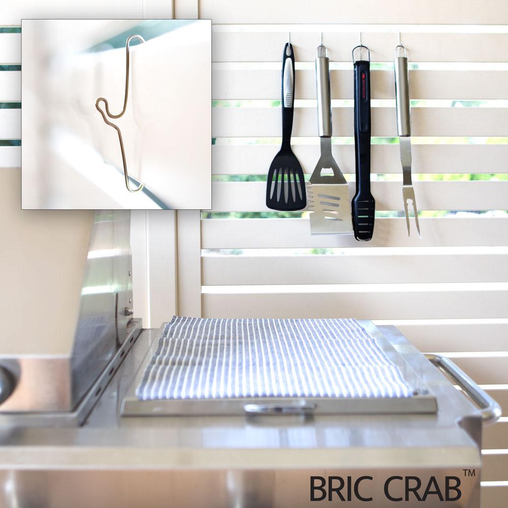 A pack of 10 stainless steel 70mm Brick Crab hooks designed for hanging items on brick walls without damage.