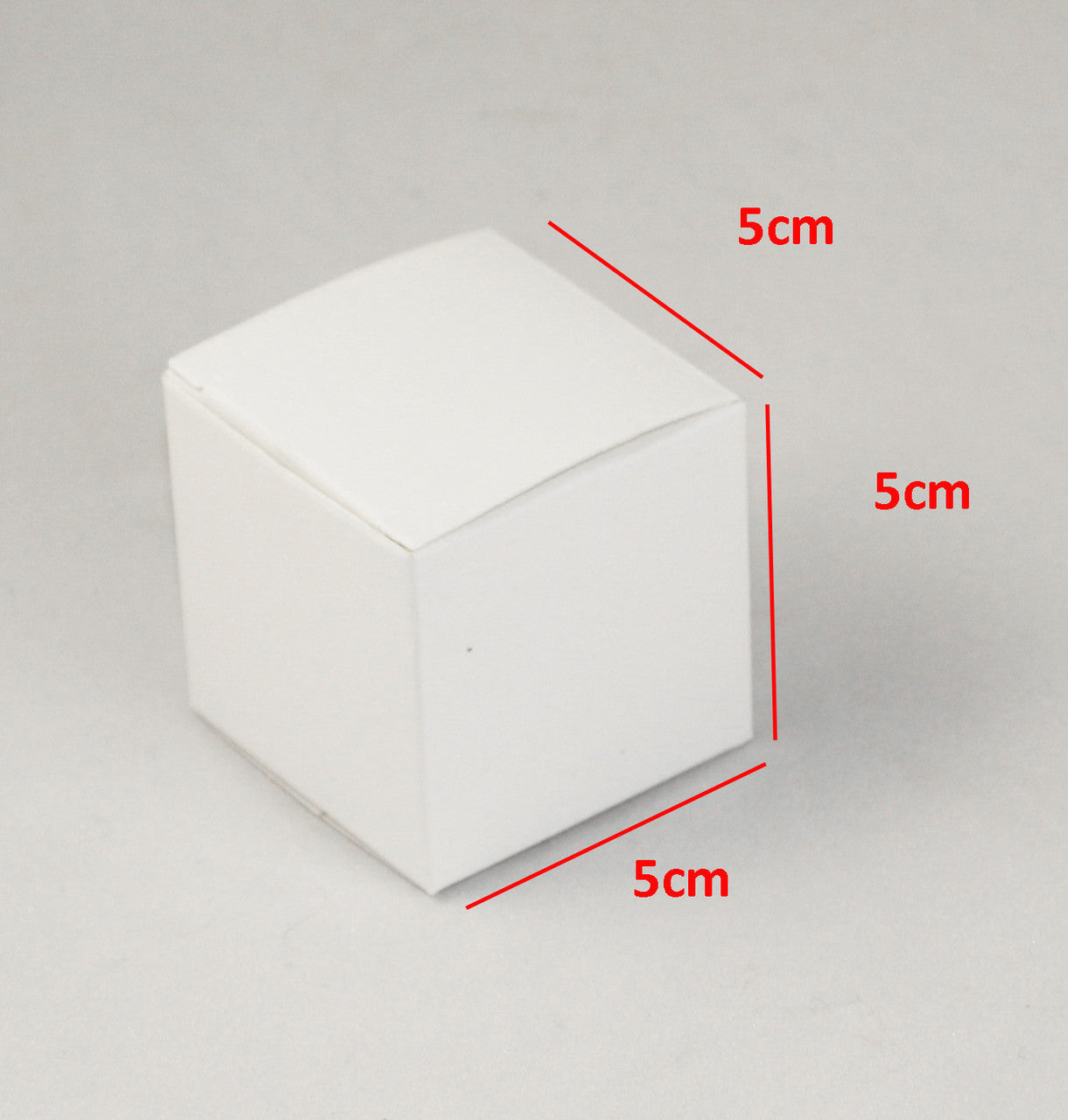 A pack of 10 white 5cm square cube gift boxes, ideal for weddings and events, neatly folded and ready for assembly.